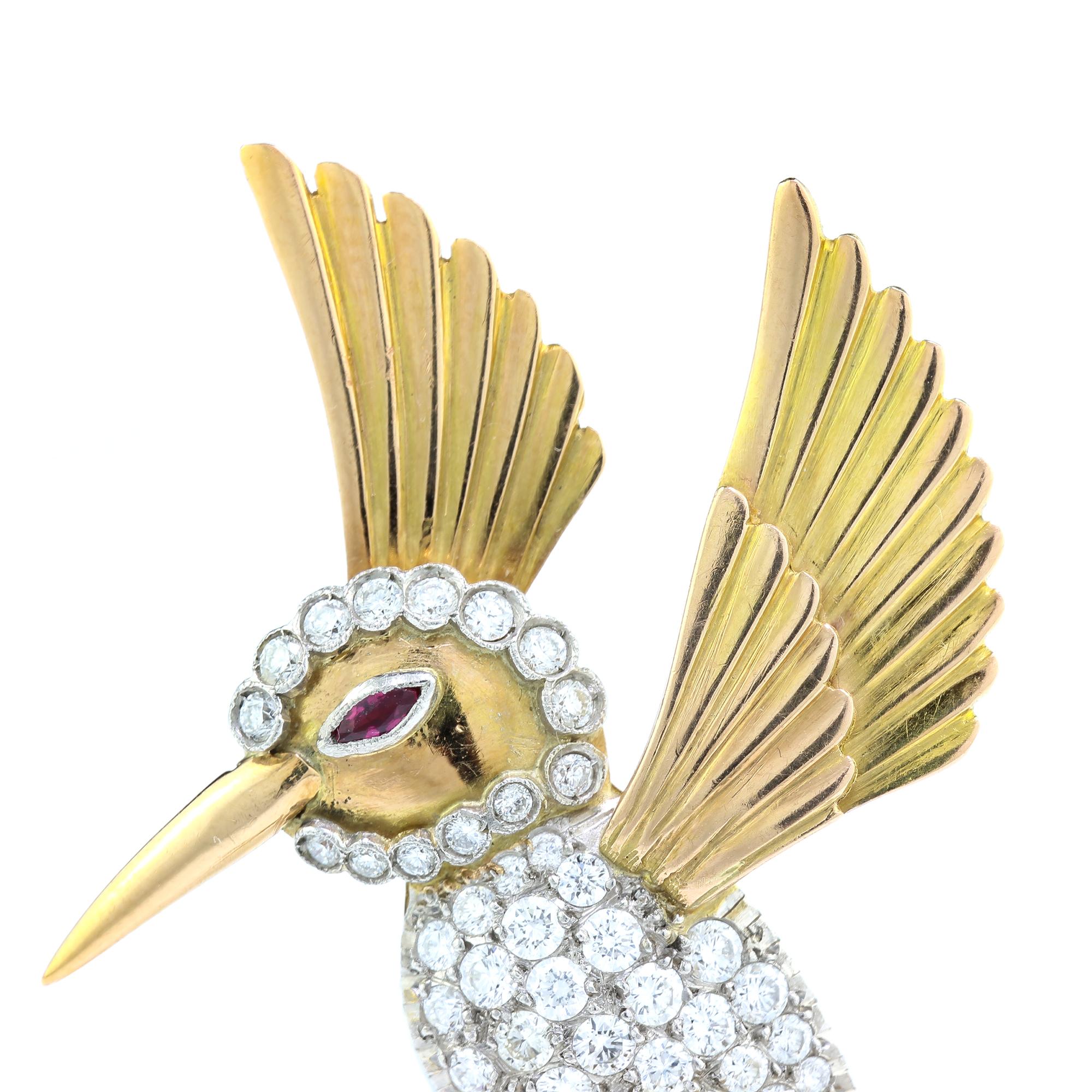 Vintage 18kt yellow gold hummingbird brooch with ruby eye and diamonds.
Made in 1950's
Tested positive for 18kt gold.

Dimensions - 
Size: 5.3 x 3.5 x 1.5 cm
Weight : 13.64 grams

Diamonds -
Cut: Round brilliant cut
Quantity of stones: 47
Approx