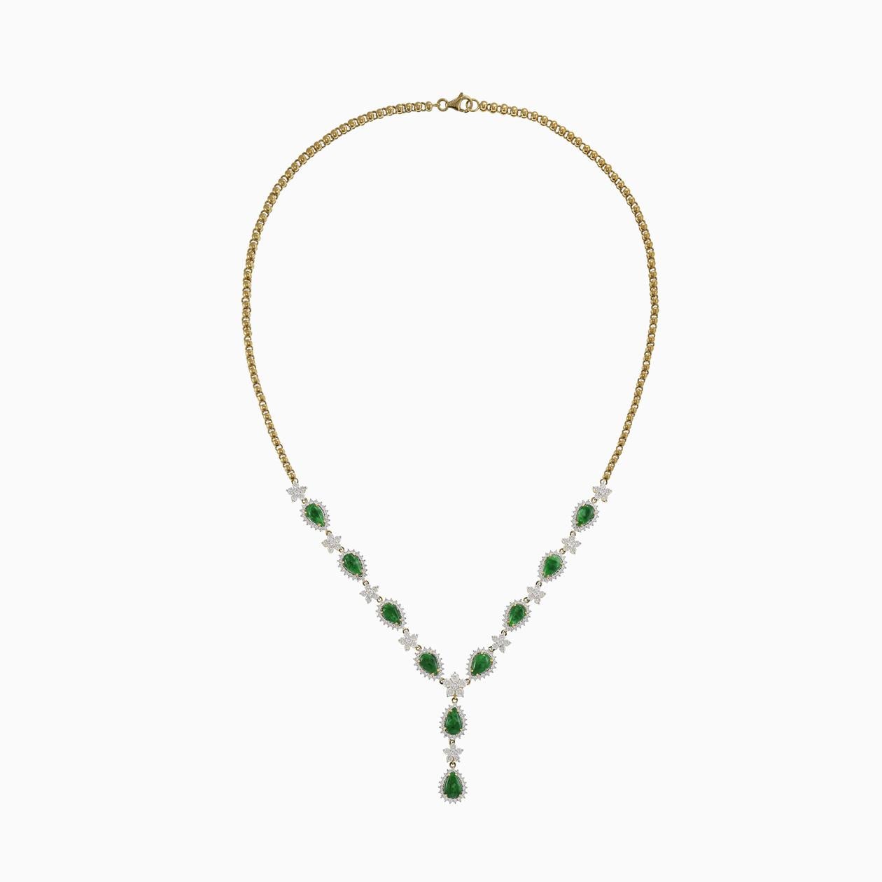 This 18KT yellow gold lariat necklace is a stunning piece of jewelry, featuring ten pear cabochon natural green jade gemstones. Surrounding the green jade are 4.65 carats in total of round-cut diamonds, which exhibit G-H color and VS/SI clarity,