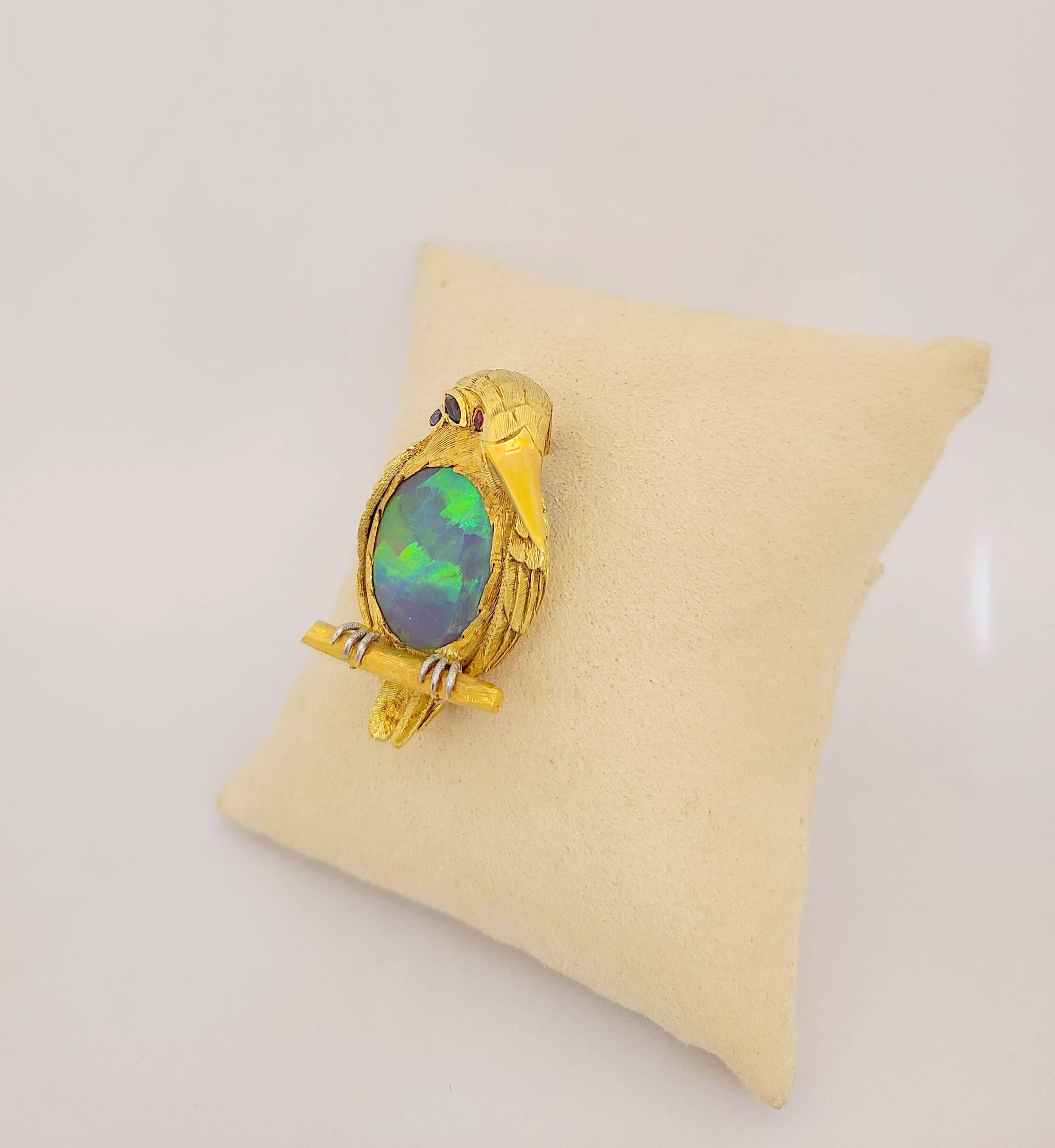 Designed as a King Puffin brooch. The artfully carved body is in 18 karat yellow gold with a sandblasted finish. The amazing feature is the birds belly which has been set with a large oval black opal . The opal has been set with the flat side facing