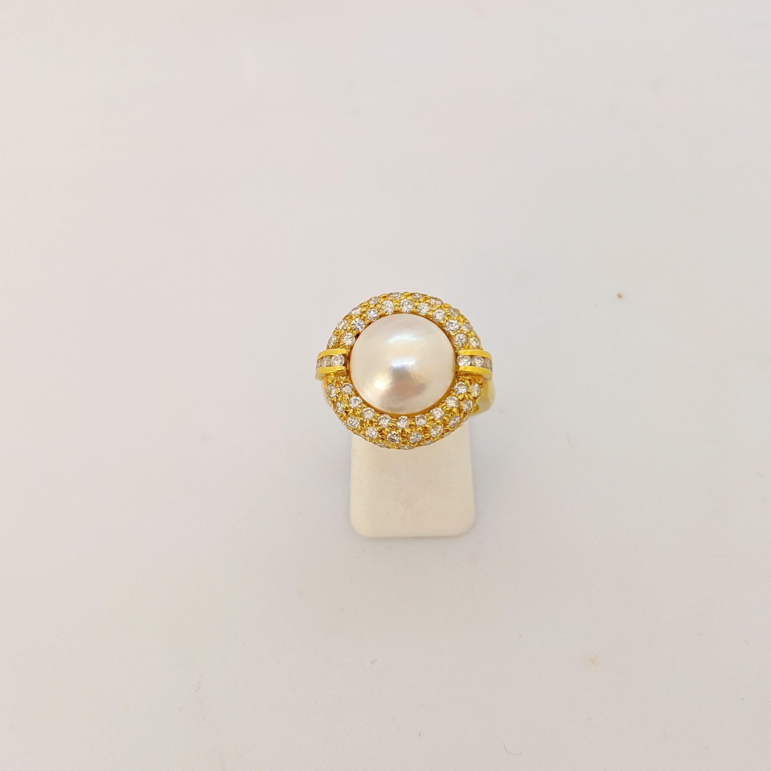 This lovely 18 karat yellow gold ring is designed with a 11mm cultured Mabe pearl center. A pave diamond halo surrounds the pearl.
Total diamond weight 1.45 carats
Ring size 6 7/8 sizing options may be available
Stamped 18KT