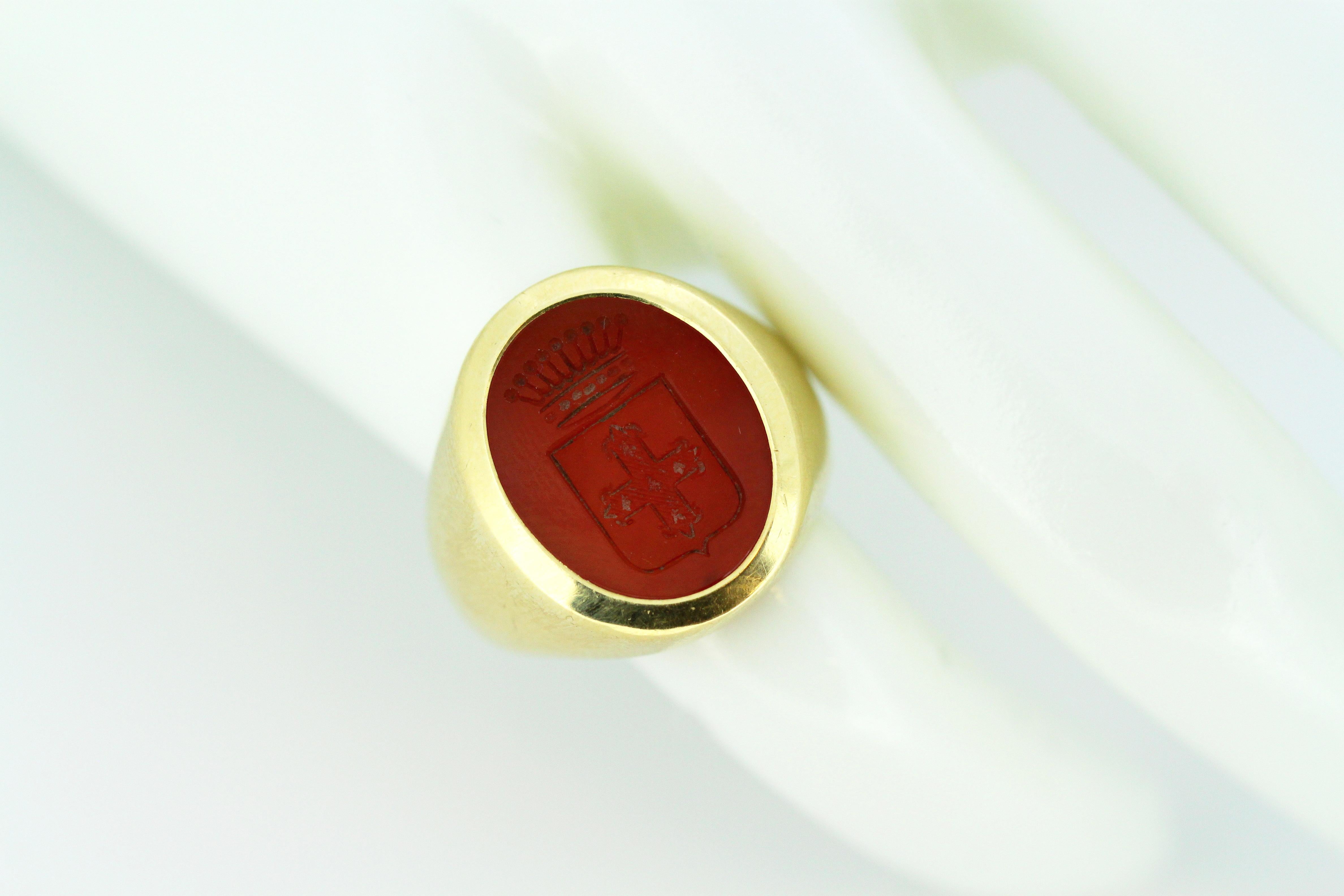 18kt yellow gold men's ring with carnelian seal with coats of arms
Hallmarked 750
Carnelian seal with coat of arms is dated late 19th century.
18kt gold ring shank is circa 1950's

Dimensions - 
Finger Size: (UK) = K (US) = 5 1/2 (EU) = 50 1/4
Ring