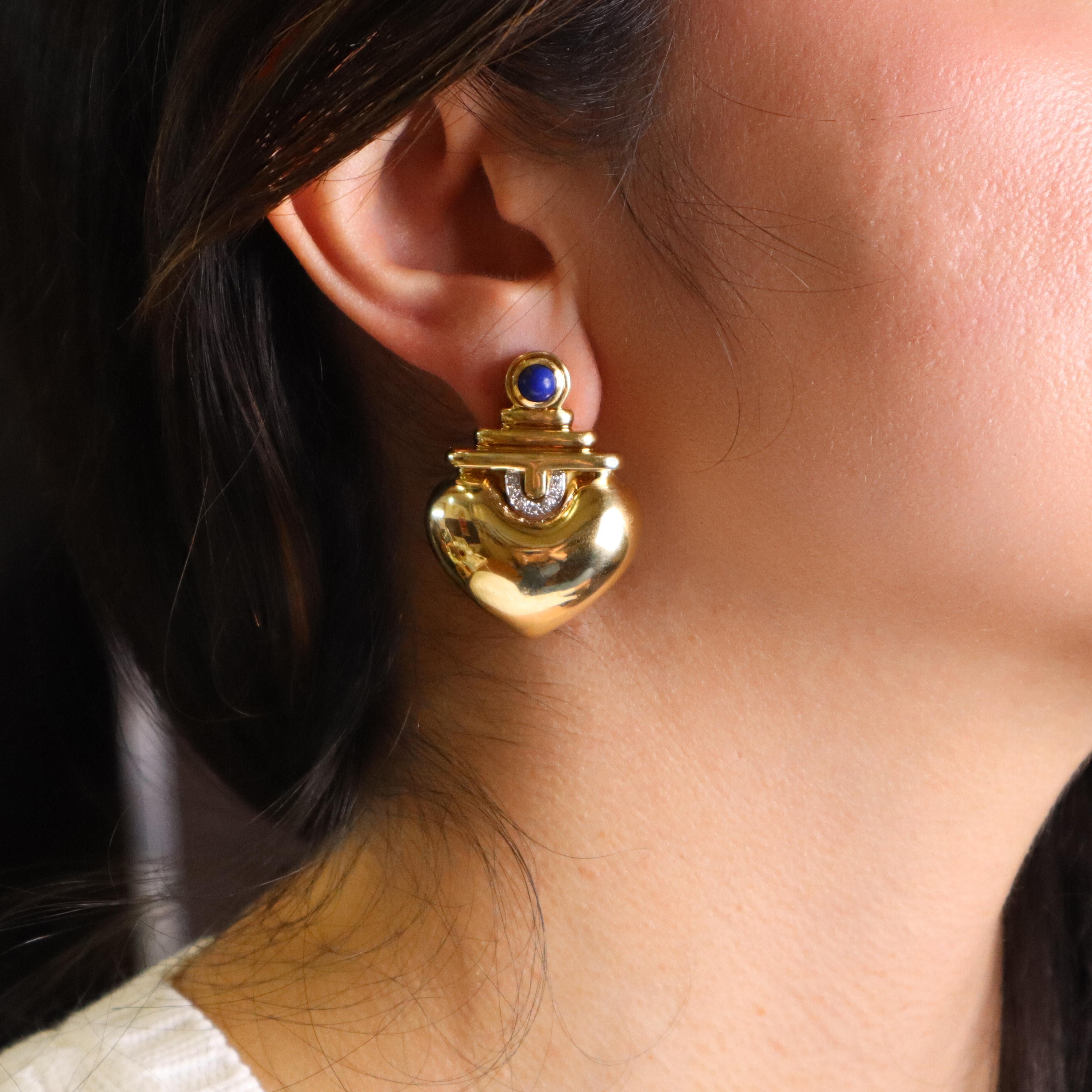 Elevate your jewelry collection with this stunning pair of 18kt yellow and white gold earrings, beautifully accented with two exquisite cabochon lapis lazuli stones. The rich, deep blue of the lapis lazuli adds a touch of elegance and