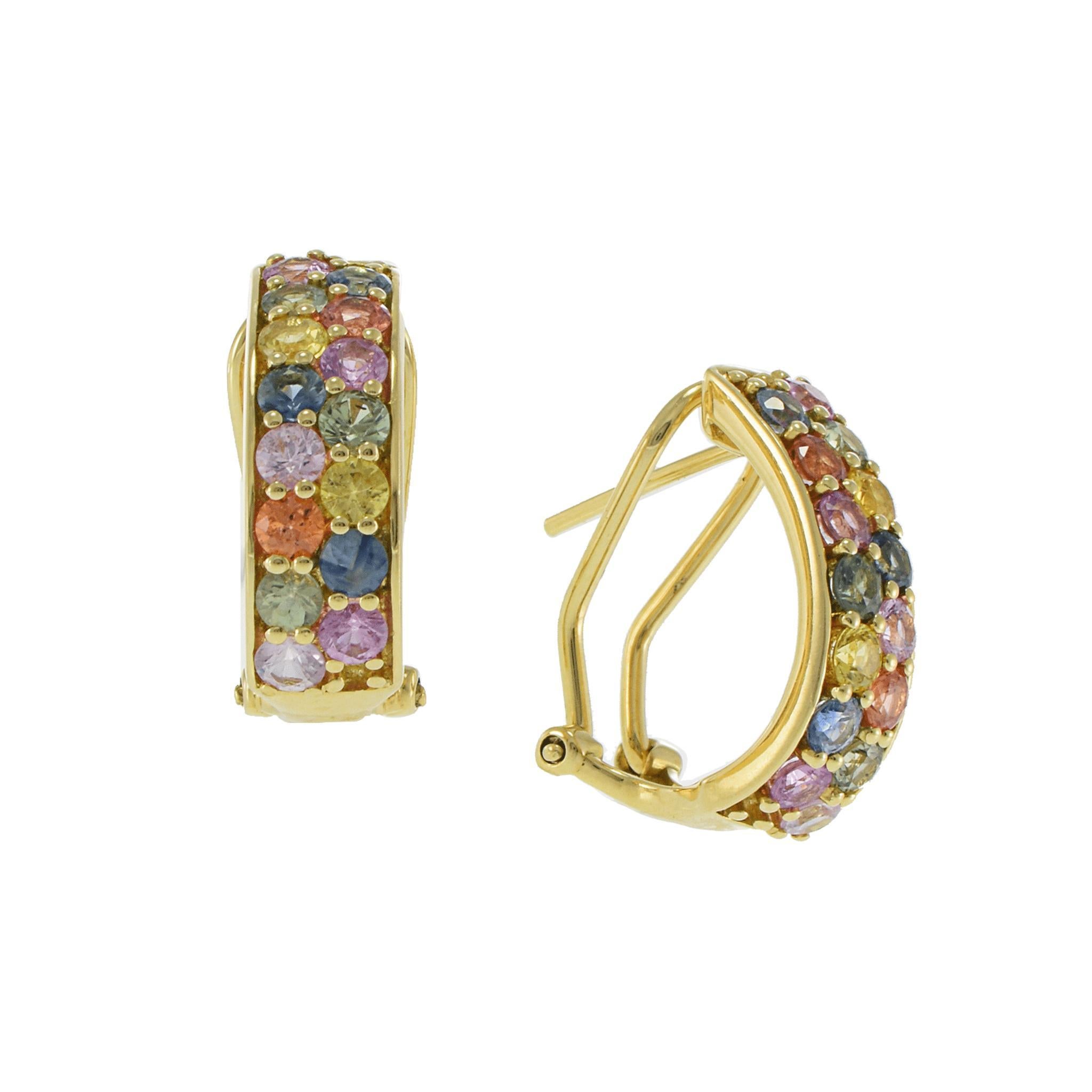 A joyful burst of color in a refined silhouette, these “U”-shaped huggie earrings are set in rich 18KT yellow gold and adorned with 3.13 carats total weight of round cut sapphires in a stunning rainbow of hues. Each gemstone is precisely placed for