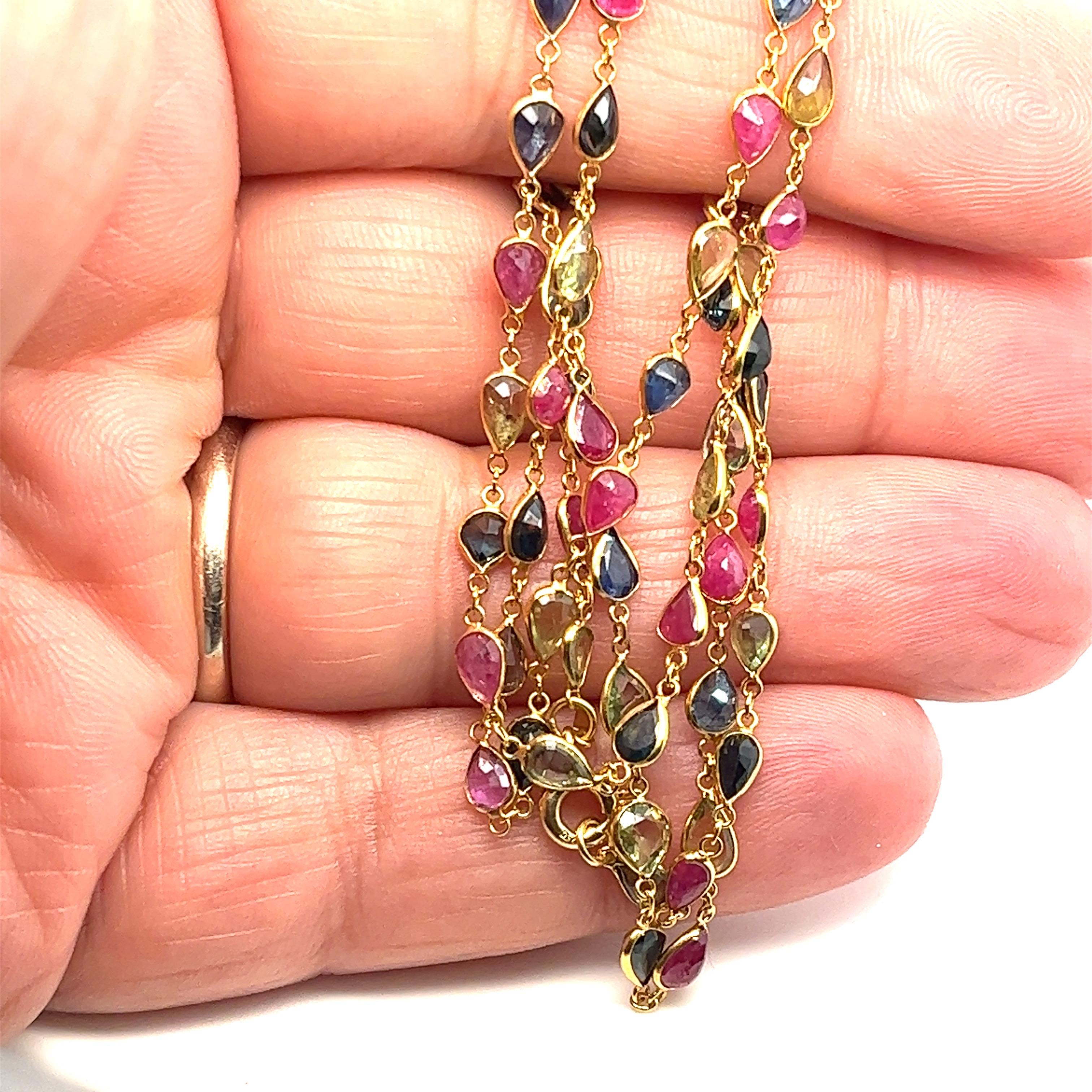 Offered here is an 18kt yellow gold precious gemstones necklace.
the necklace comprises of pear shaped multi color genuine earth mined sapphires and natural earth mined rubies, each individually set in bezels. the gemstones are separated by a fine