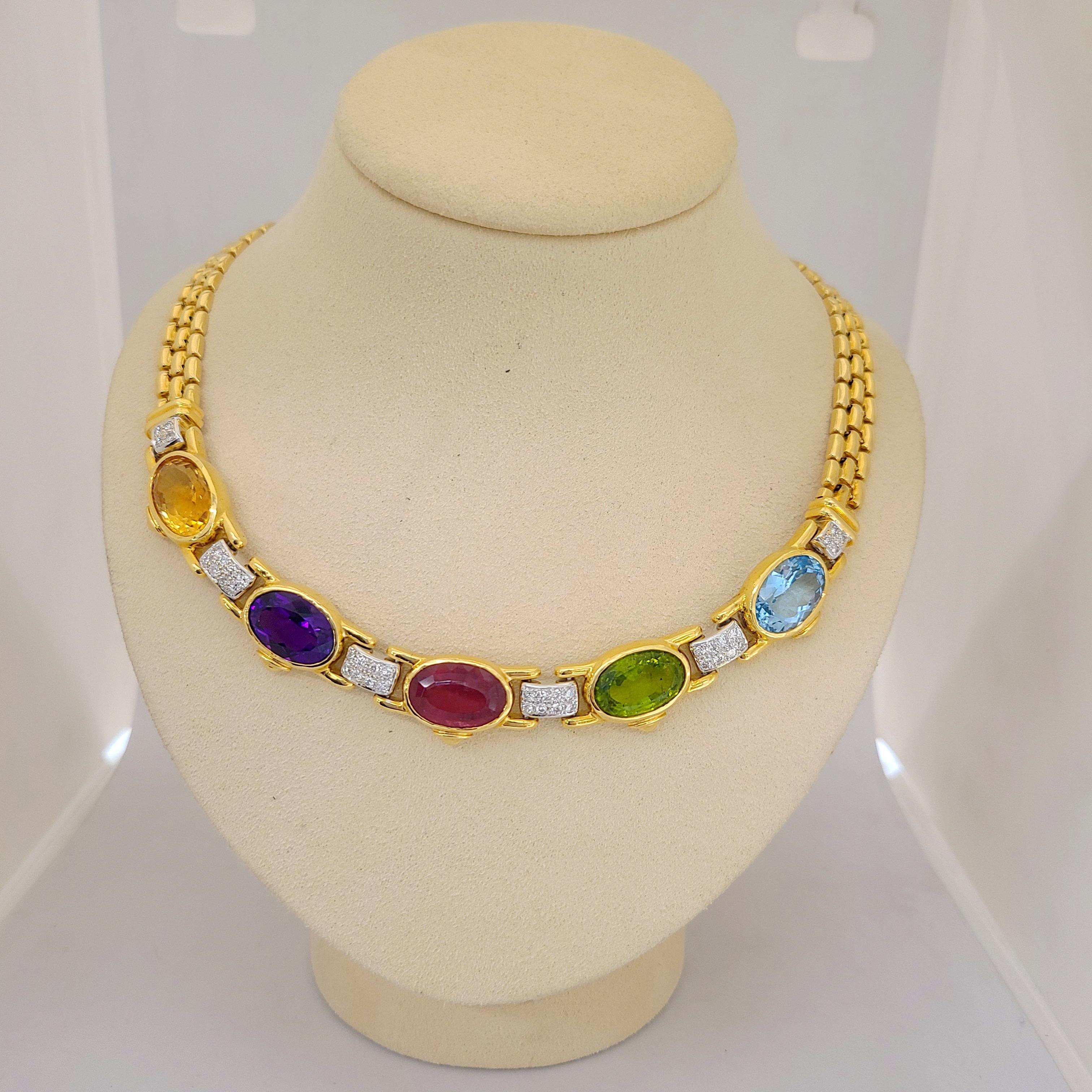 From Cellini Jewelers NYC comes this very classic and wearable necklace. The 18 karat yellow gold necklace is designed with 5 oval semi precious stones: citrine, amethyst, pink tourmaline ,peridot and blue topaz. White gold diamond set links connect