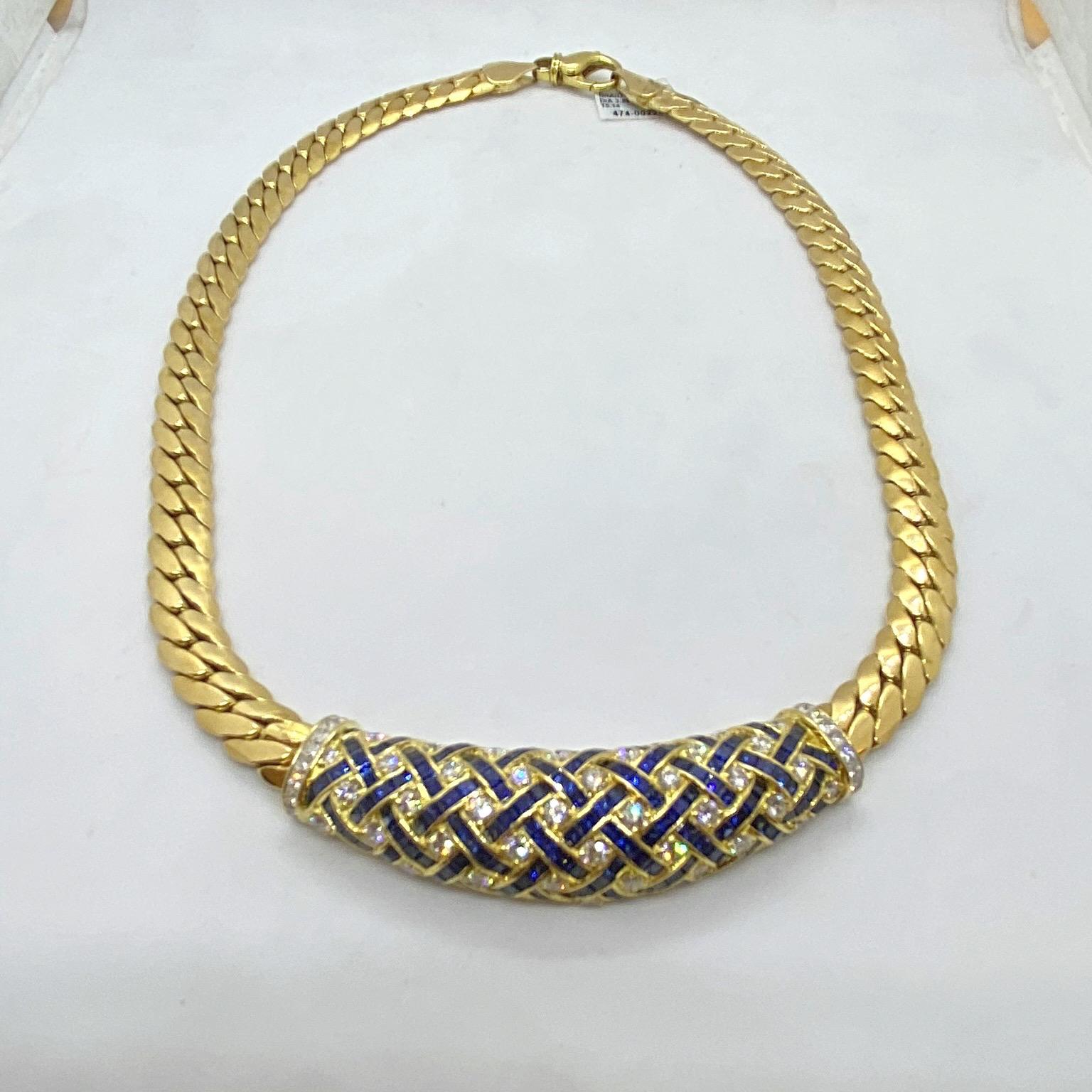 The highlight of this 18 karat yellow gold necklace is the beautiful center section. Round Brilliant Diamonds and Square Cut Blue Sapphires are set in a basket weaved pattern amid a 2 5/8