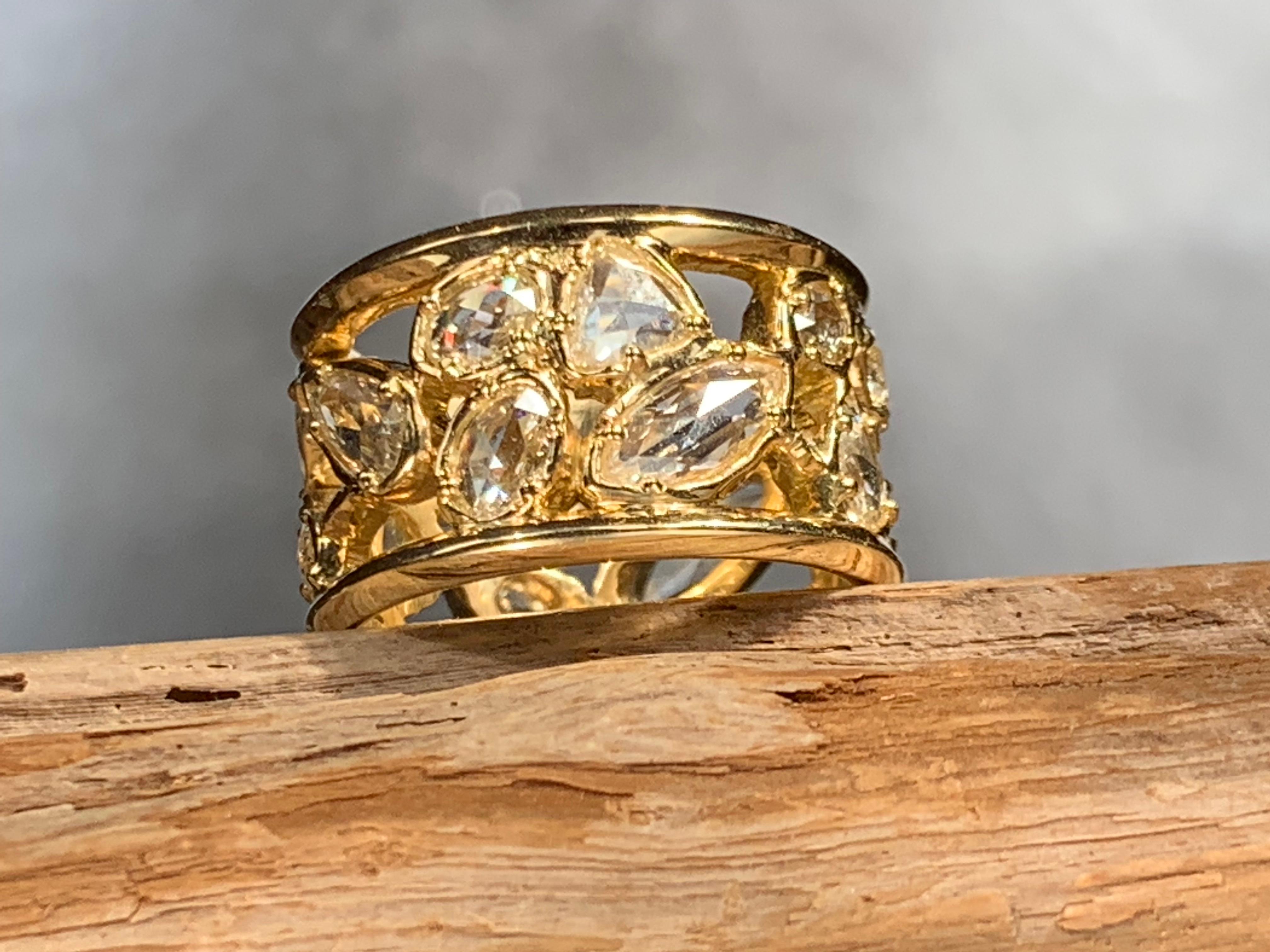 From a series of one-of-a-kind wide band rings, this substantial 18kt yellow gold organically sculpted  half inch wide band is a composition of waves of sparkling fine white rose cut diamonds of various shapes and sizes.
This style of ring can be