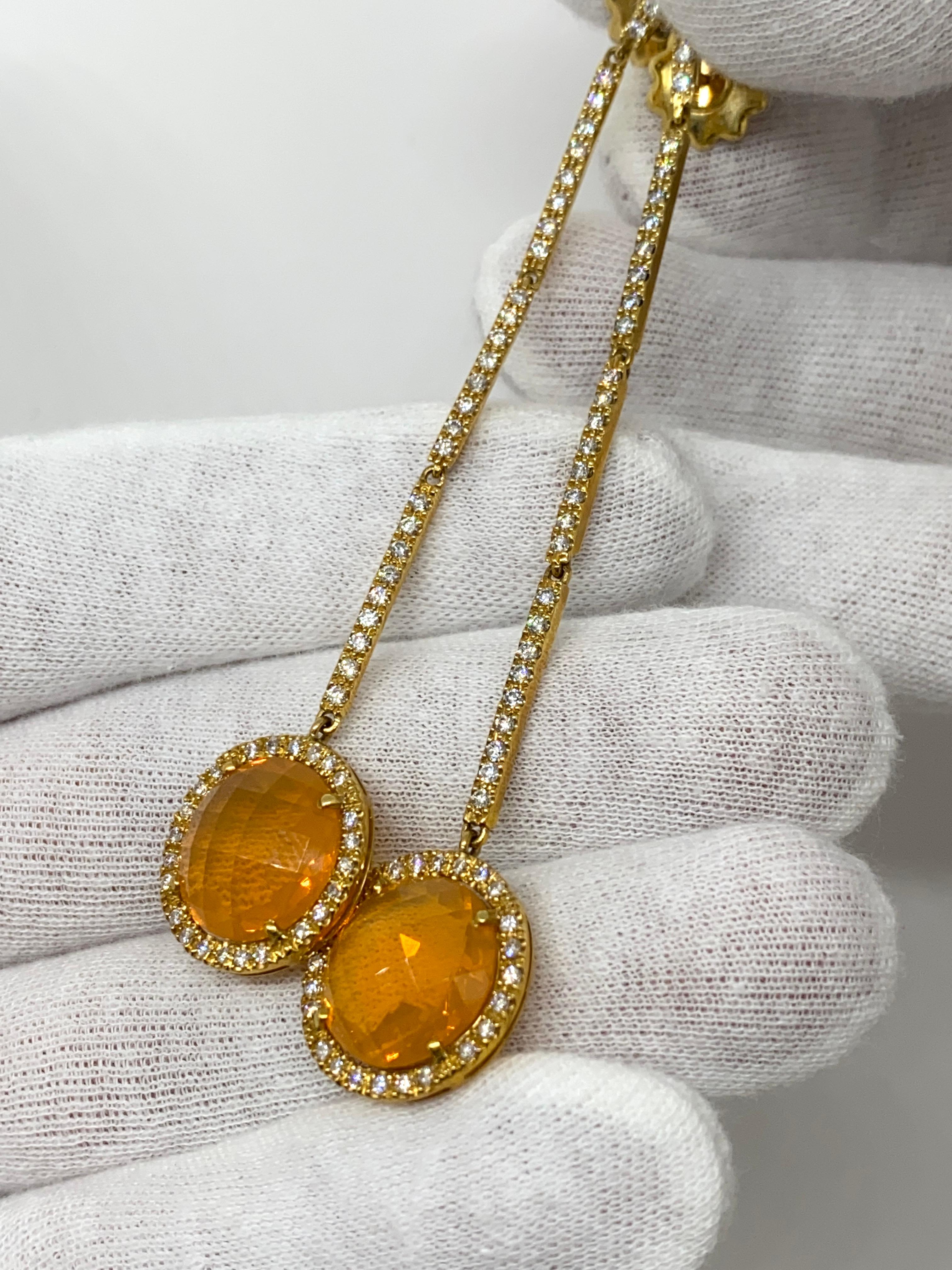 Dangling earrings made of 18kt yellow gold with natural brilliant-cut diamonds for ct.2.17 and faceted-cut Orange opal

Welcome to our jewelry collection, where every piece tells a story of timeless elegance and unparalleled craftsmanship. As a