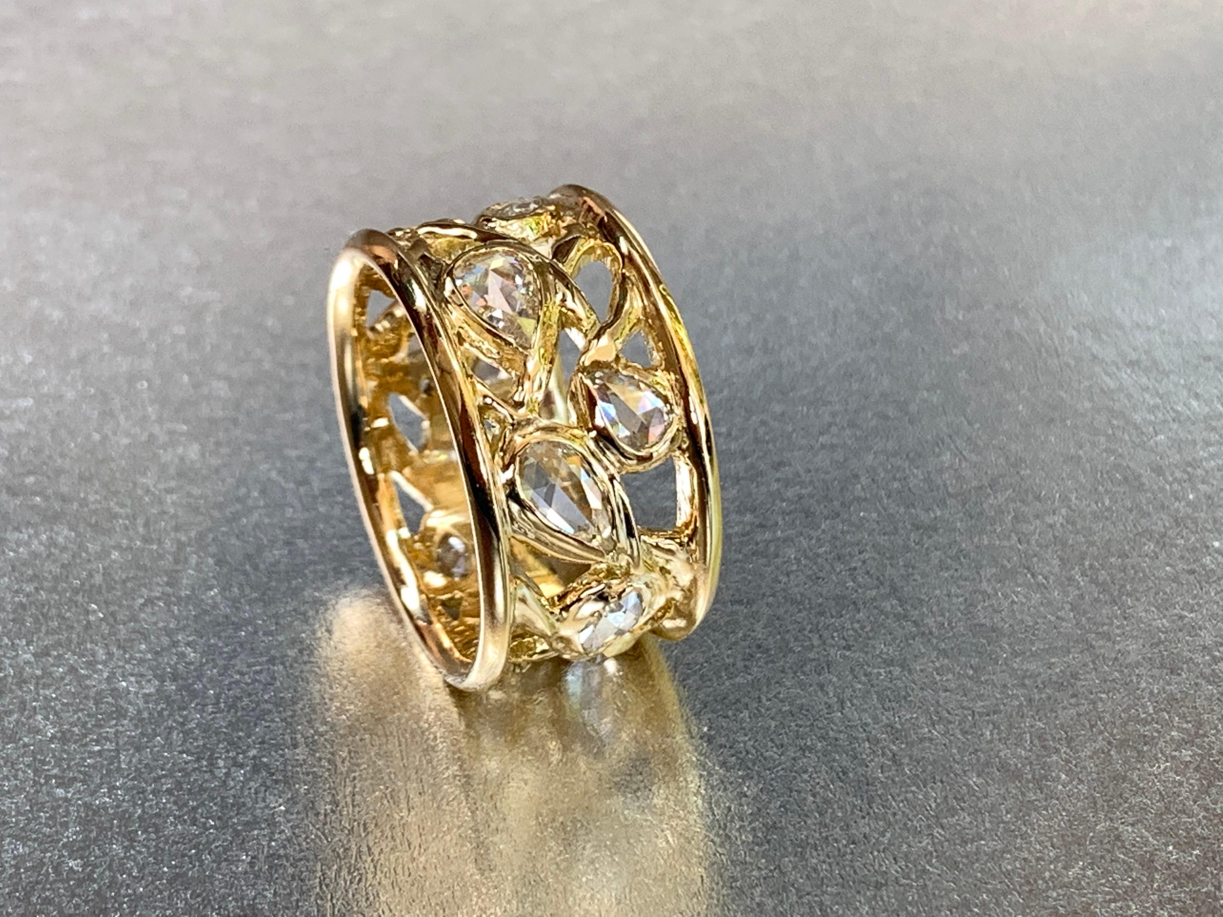 From a series of one-of-a-kind wide band rings, this 18kt yellow gold organically sculpted ring is a composition of waves of sparkling fine white rose cut diamonds of various sized pears and marquises. 
This style of ring can be made to order for