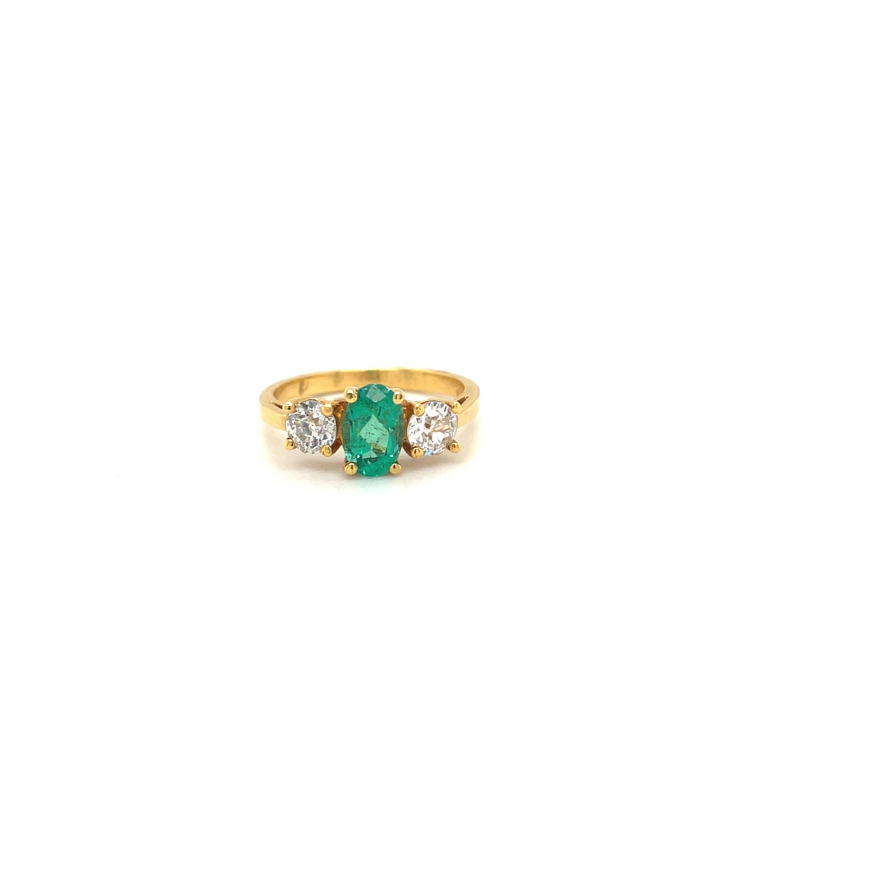 Contemporary 18kt Yellow Gold Oval 57ct. Emerald and .46ct. Diamond Ring For Sale