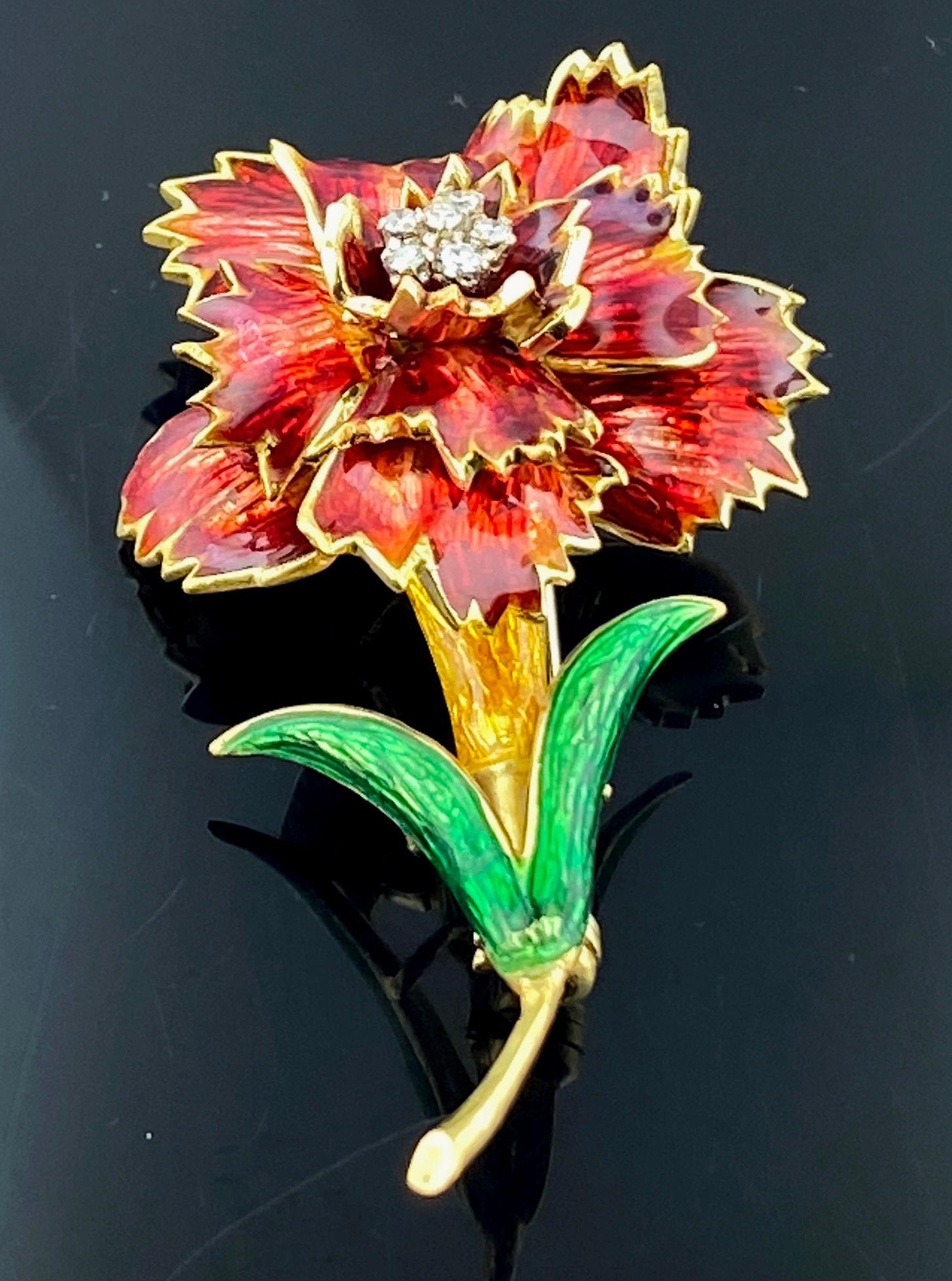 Set in 18 karat yellow gold, weighing 15 grams, is a lovely flower on a stem, painted with vivid colors and including 6 small round brilliant cut diamonds in the center.