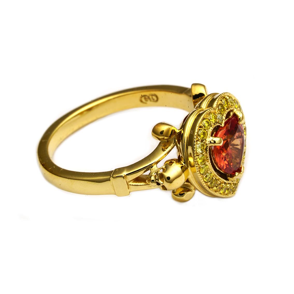 The Lavish Amour Ring is an exquisitely vibrant piece. 

Handmade in 18kt yellow gold the ring features a luminous, 6mm, heart shaped sapphire, the striking peach coloured stone is shrouded by vivid, pave set, yellow diamonds. A split ring shank