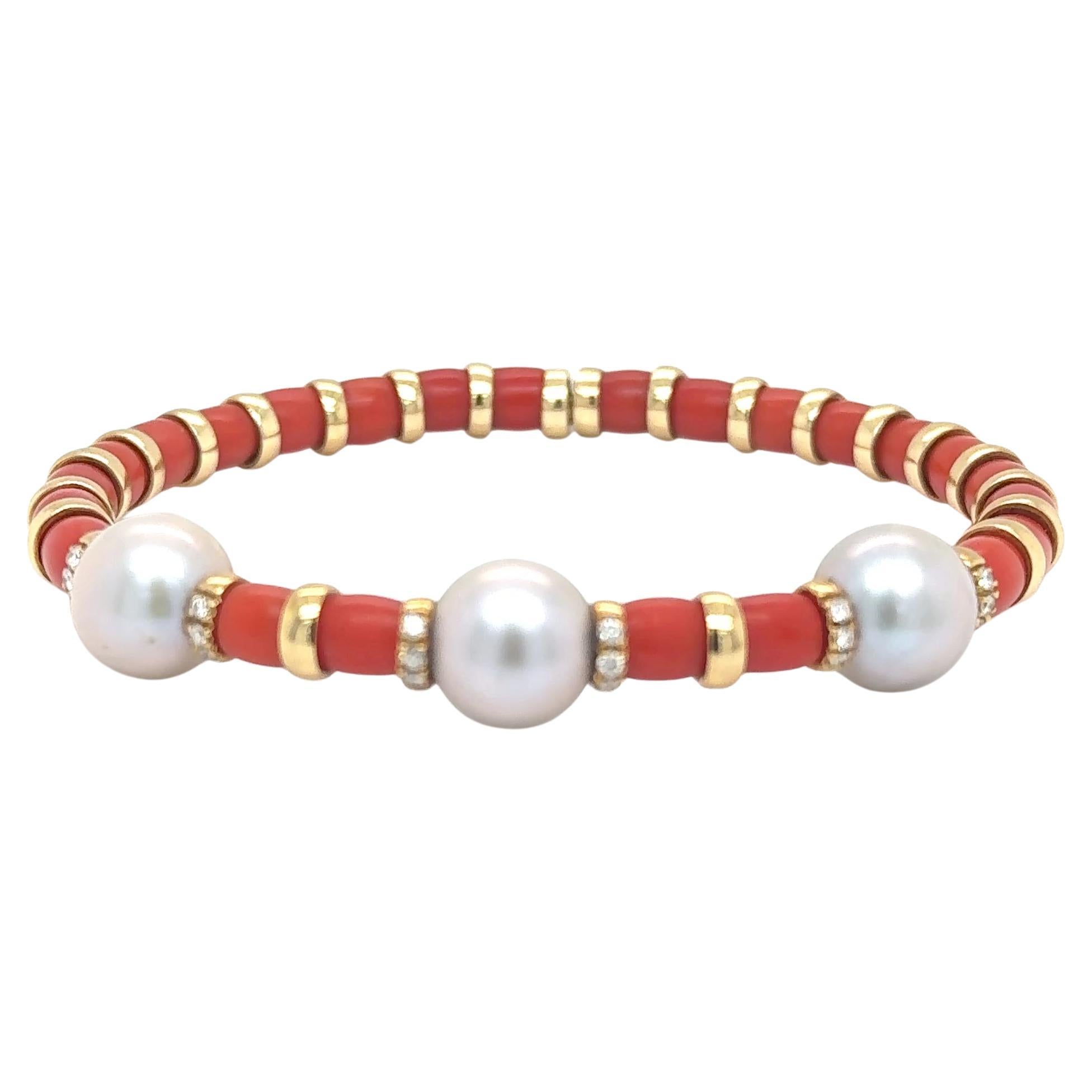 Luminous 10 mm South Sea pearls, renowned for their exceptional size and satiny lustre , are artfully paired with warm red coral beads and strung on gleaming 18 kt yellow gold. Accented by 18 delicate diamonds totaling 0.14 carats, the bracelet