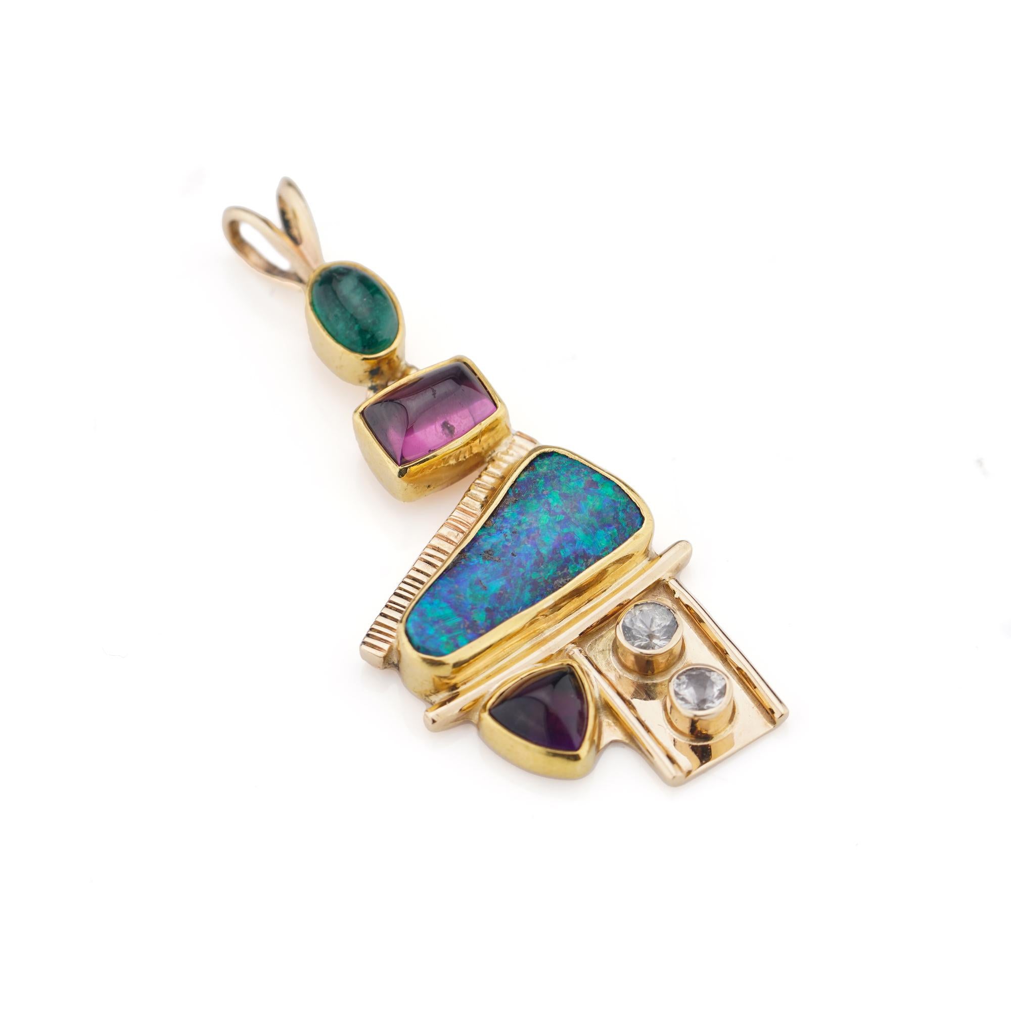 14kt yellow gold pendant with opal, diamonds, emerald, amethyst, and pink spinel. 
Made in the 1990s
Tested positive for 14kt. gold. 

Dimensions - 
Weight: 6.24 grams
Length x width x depth: 4.5 x 2 x 0.5 cm 

Opal -
Cut: triangular 
Size: 15 mm
