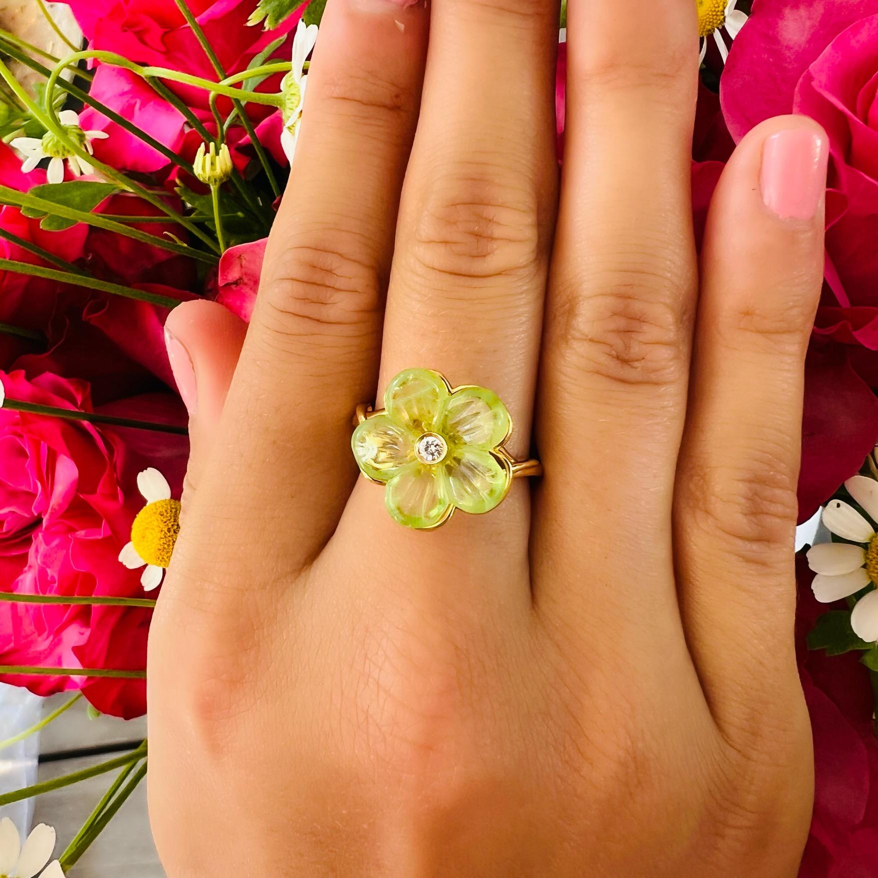 Vibrant green carved peridot accented with a diamond center come together in this eye-catching ring by the one and only Ferragamo. As stylish as it is wearable, this Ferragamo ring with a yellow gold twisted band and overall floral design is sure to