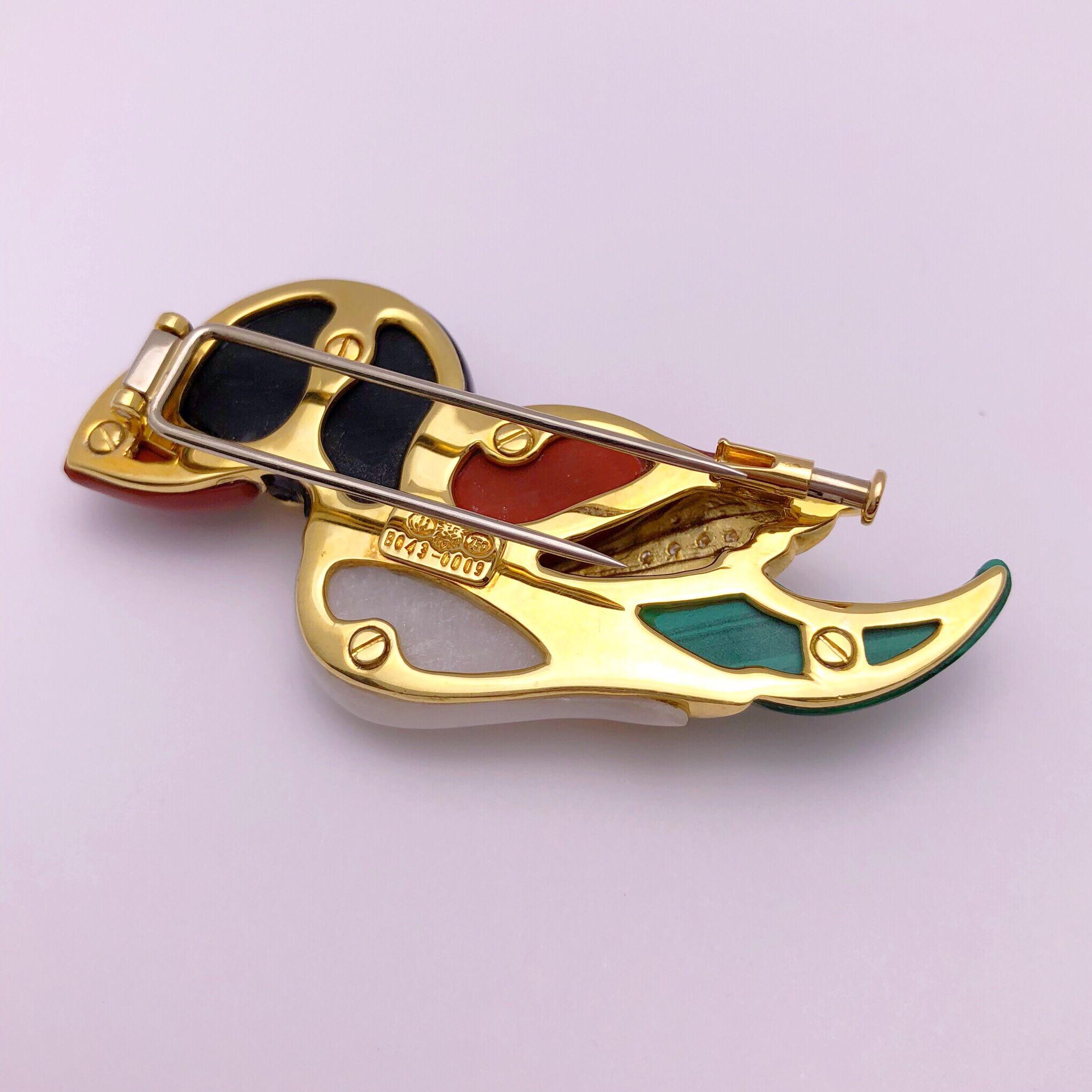 A true work of craftsmanship is the best way to describe this Puffin brooch. Smooth and hand polished stones of Jasper, Agate, Malachite and Onyx form the sculptural birds body. White round brilliant diamonds weighing 0.14 carats are set in the