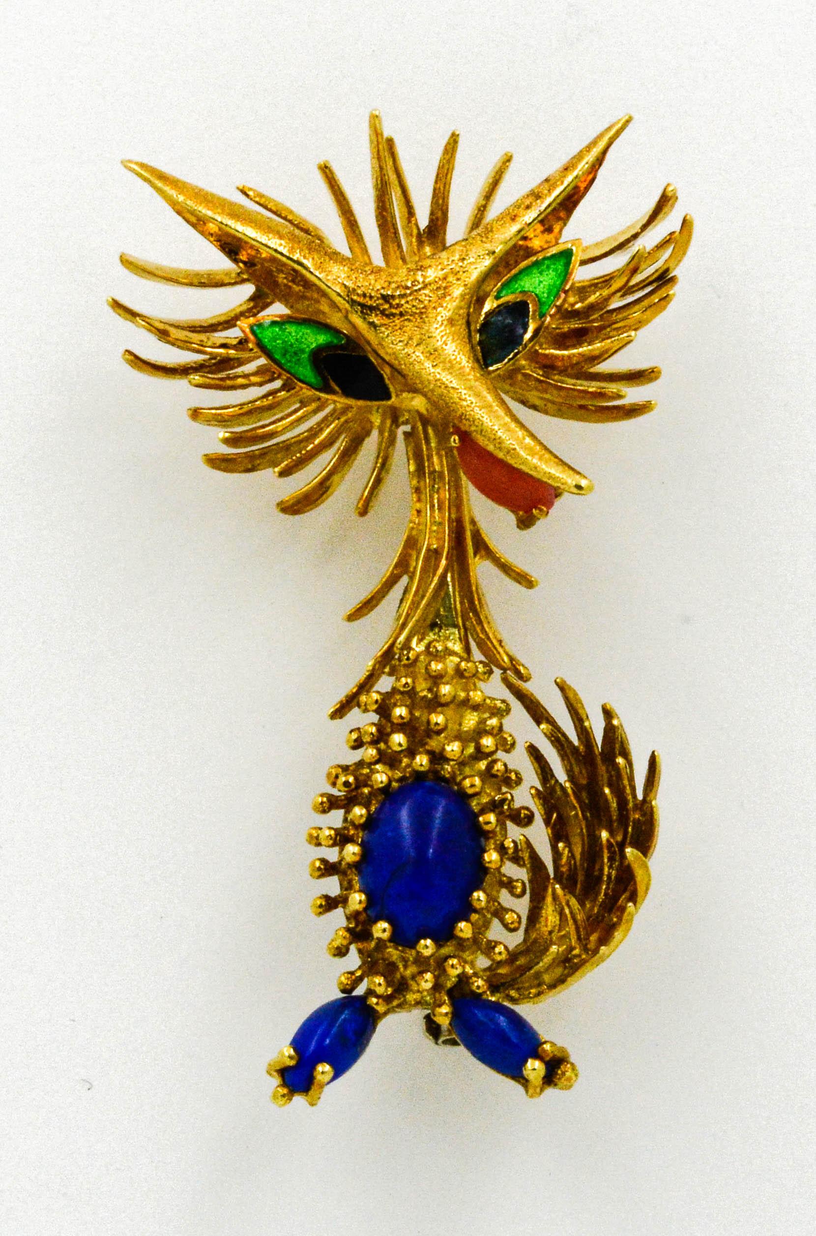 Circa 1945-1950 in a Retro style, we offer this stylized Toliro Animal. This roadrunner brooch is 18 karat yellow gold and set with 3 cabochon cut Lapiz Lazuli, 1 cabochon Coral, and accented with enameling.