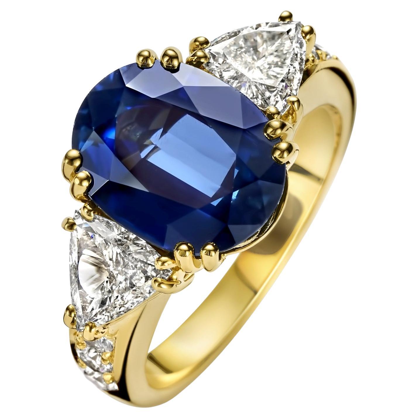 Magnificent 18kt Yellow Gold Ring With Beautiful 6.68ct Sapphire & 1.07 ct Large Triangle Diamonds +6 Round Brilliant Cut Diamonds 
Sapphire: Oval mixed cut natural sapphire, blue transparent, 6.68ct Comes with IGI certificate

Diamonds: Triangle