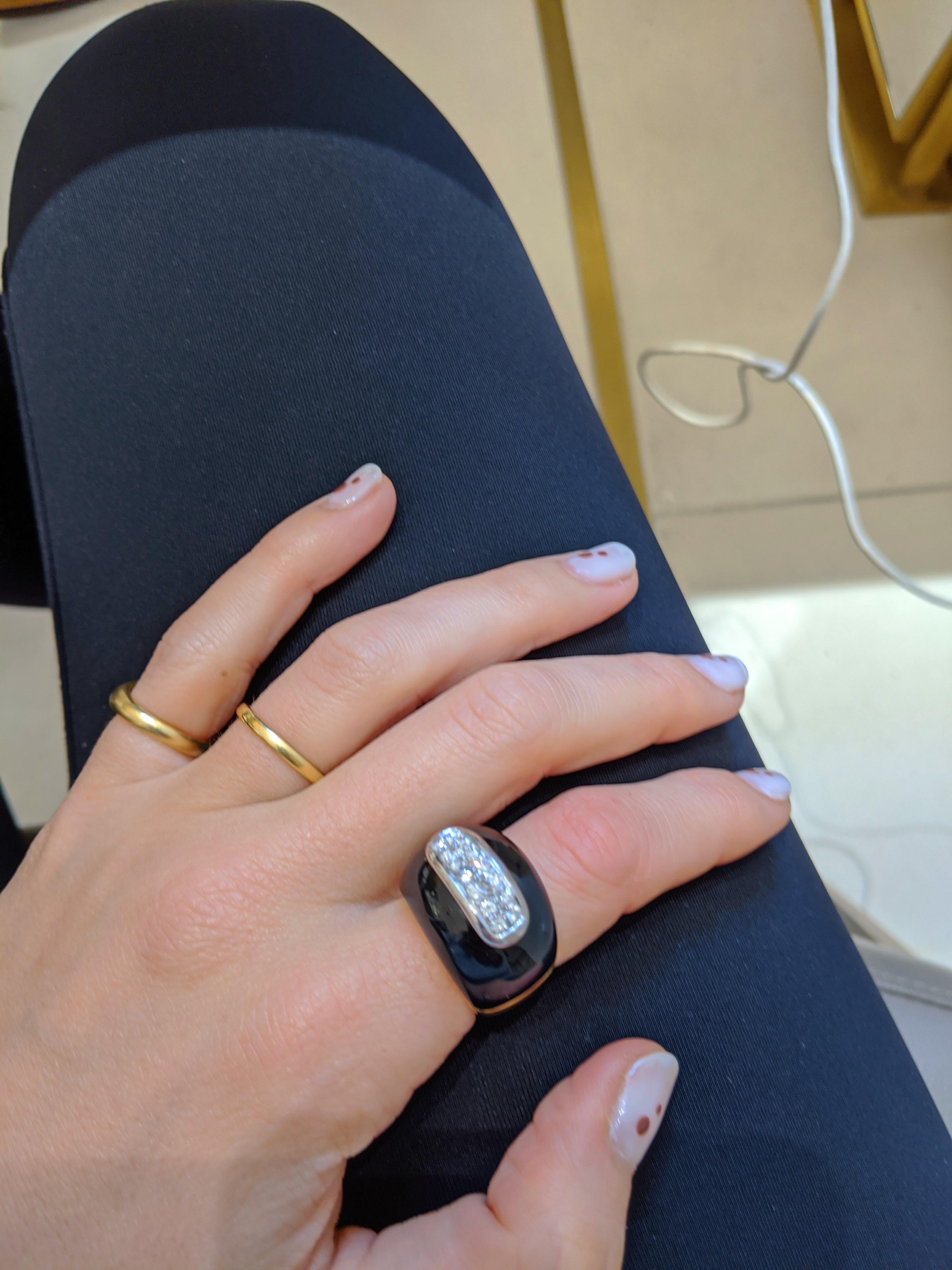 Retro 18 karat yellow gold ring designed with a dome of Black Onyx.  Fourteen round brilliant Diamonds set in a  white gold are bezel set on top of the Onyx.
Total Diamond weight 0.42 carats
Finger size 6 3/4
