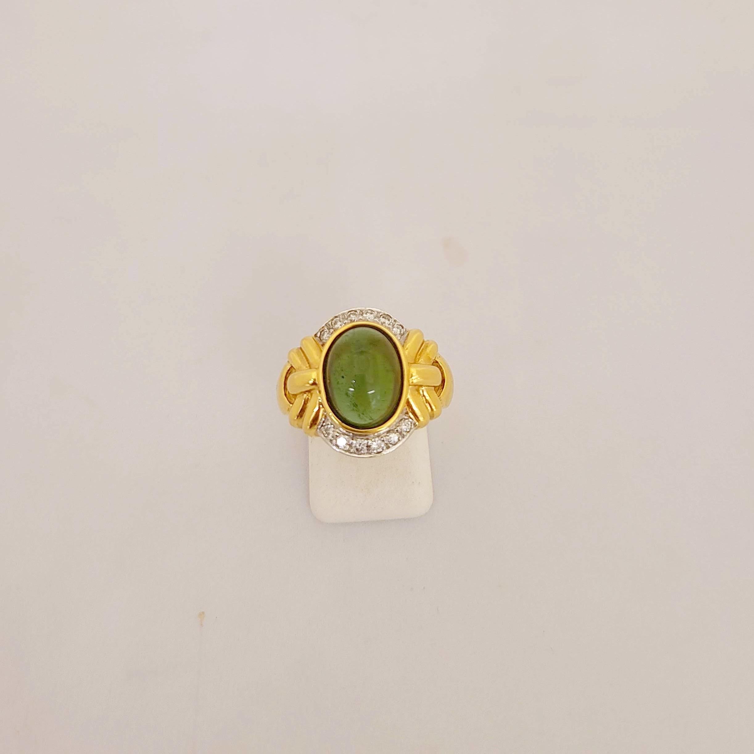  Cabochon oval green tourmaline center stone with diamond accents set in 18 kt yellow gold.
Diamond weight 0.25 carats
Stamped 750
Ring size 6.25  sizing options may be available