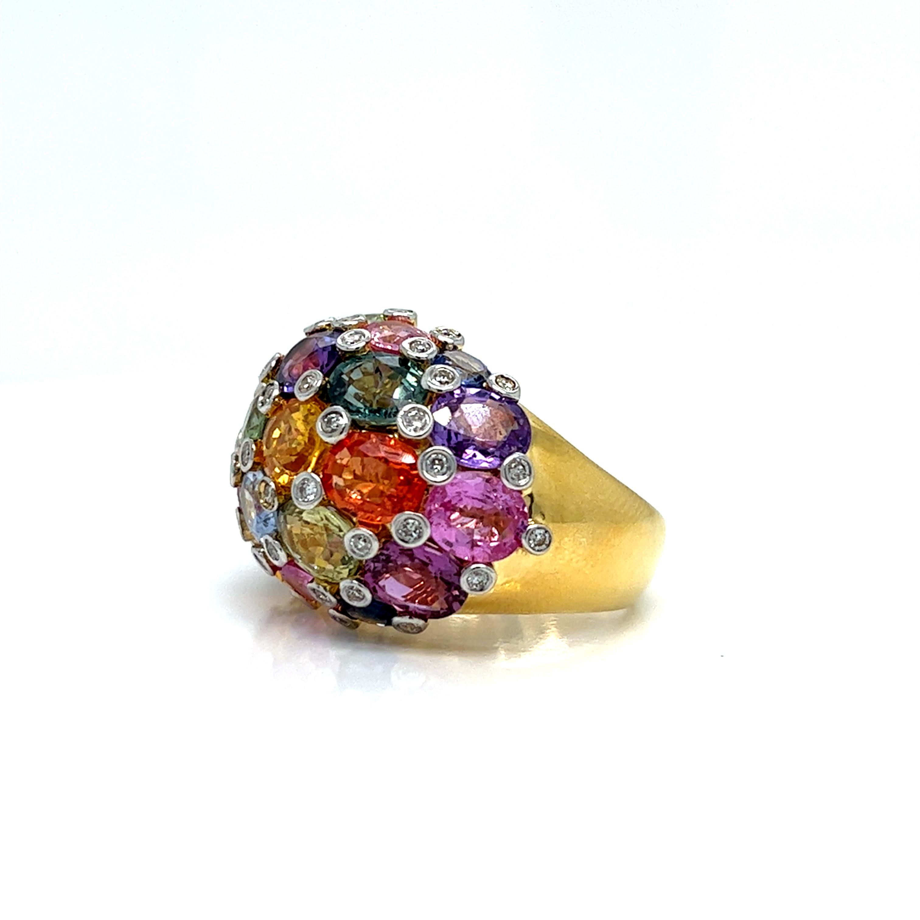 This dome design ring is a luxurious piece crafted in Italy, made from 18kt gold. It's adorned with natural color sapphires and round diamonds, promising and exquisite combination of gemstones set in a captivating design. A true statement of