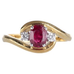 Anillo de oro amarillo de 18 quilates con rubí ovalado y detalles de diamantes