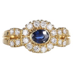 Anello in oro giallo 18kt con zaffiro ovale e diamante a raggiera
