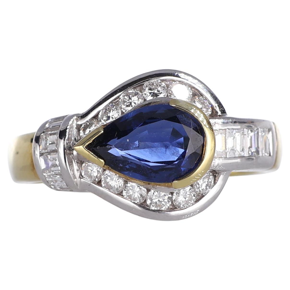 Anillo de oro amarillo de 18 quilates con zafiro talla pera y montura de diamantes