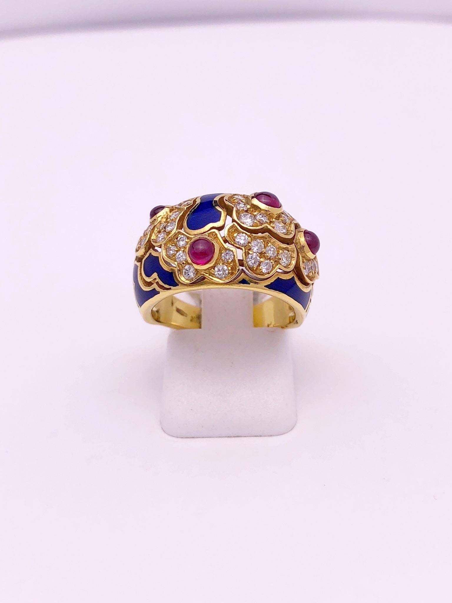 This lovely ring features a pattern of organic shaped flowers set with round brilliant diamonds. Each of the 4 flowers are set with a cabachone ruby. Blue enamel organic shapes finish off the ring which is entirely set in 18 karat yellow