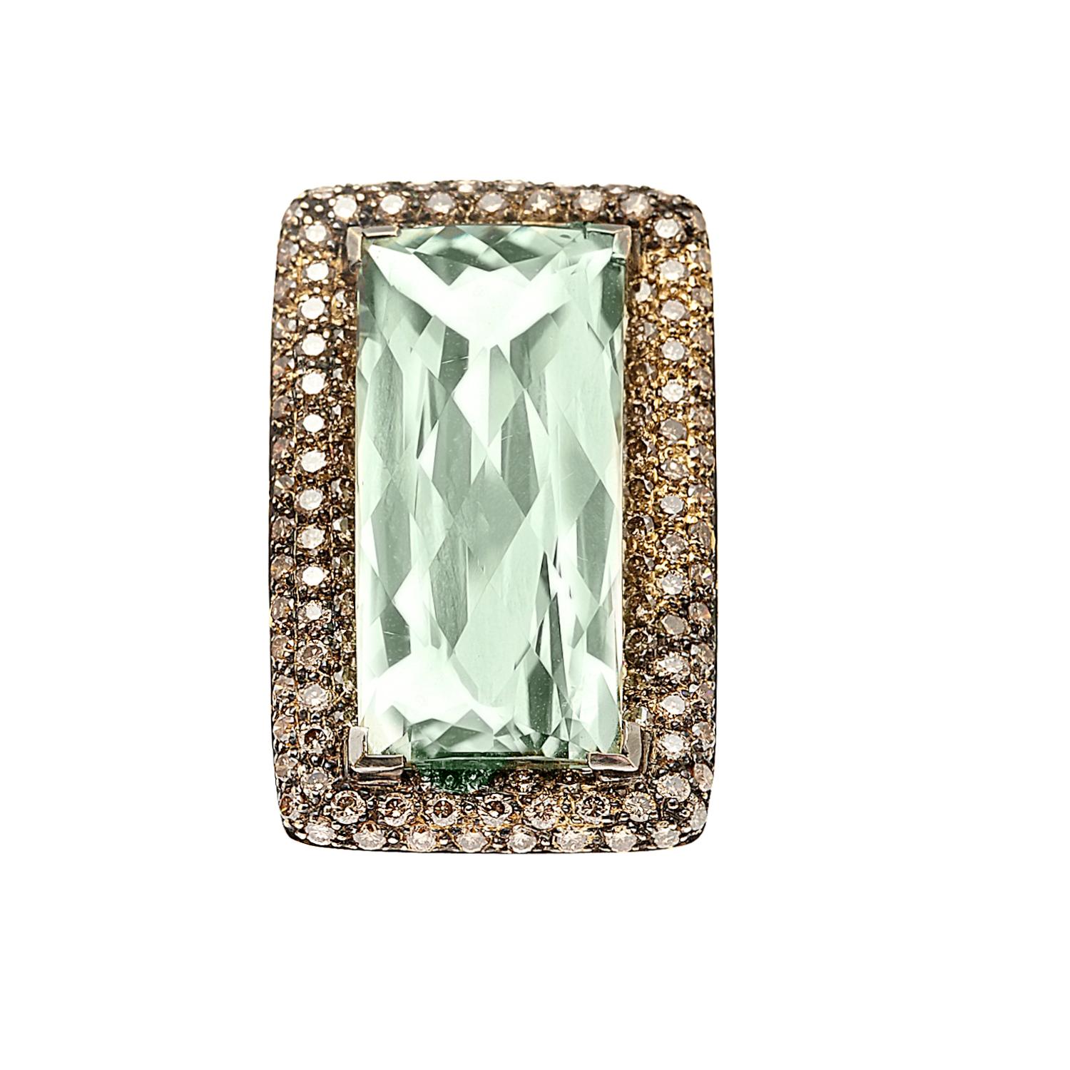 This stunning large cocktail ring features a large 18ct unique green amethyst center stone with an interesting faceting pattern. The stone is surrounded by 2.03ct of small shimmering brown diamonds to complete the piece.