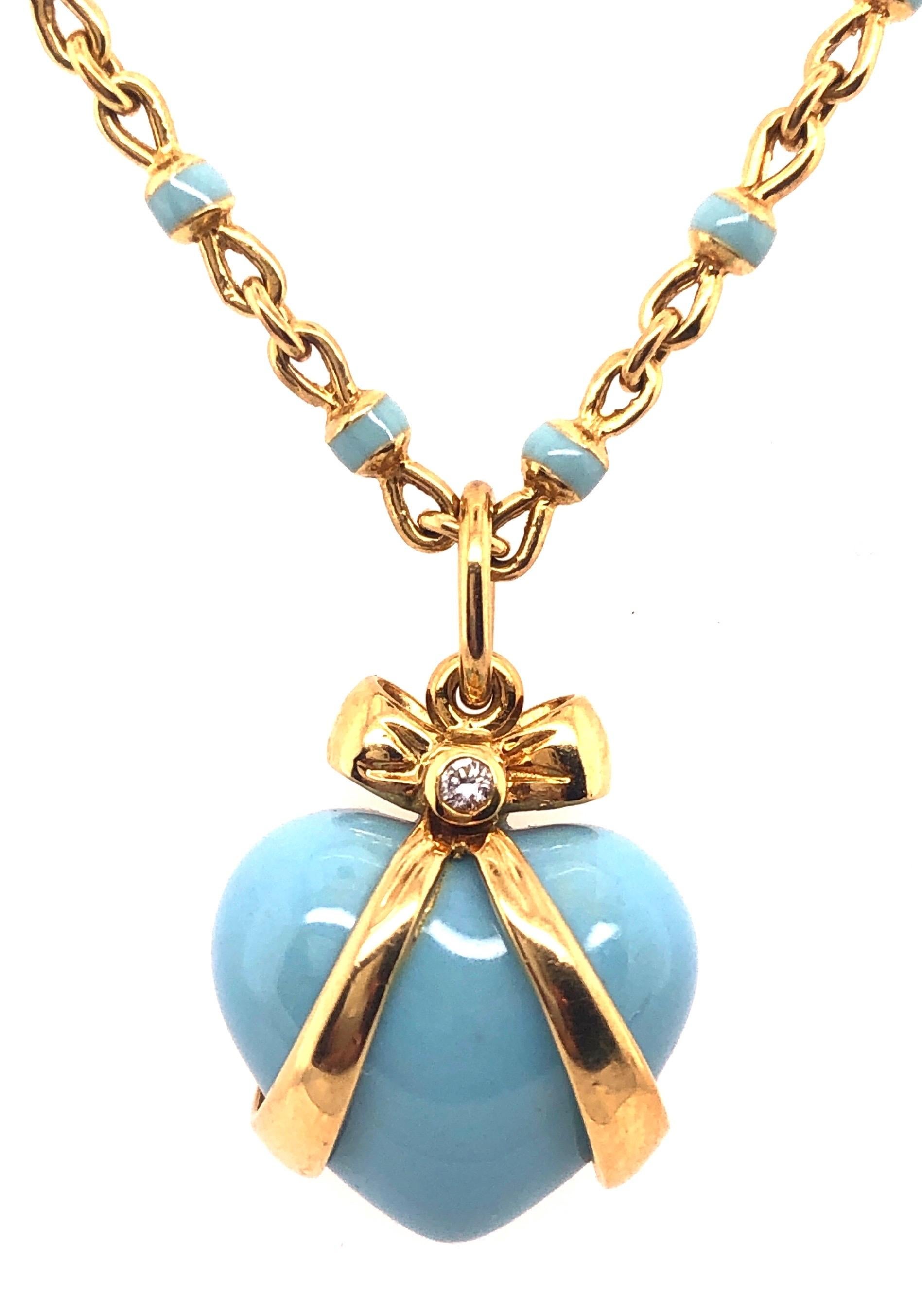 18Kt Yellow Gold Robert Bielka Neckalce with Enamel Heart Pendant with Diamond.
Bielka 18k Gold & Turquoise Enamel Heart Pendant. Turquoise enamel heart pendant, wrapped in an 18k yellow gold bow and accented by round-cut diamonds. Two diamonds