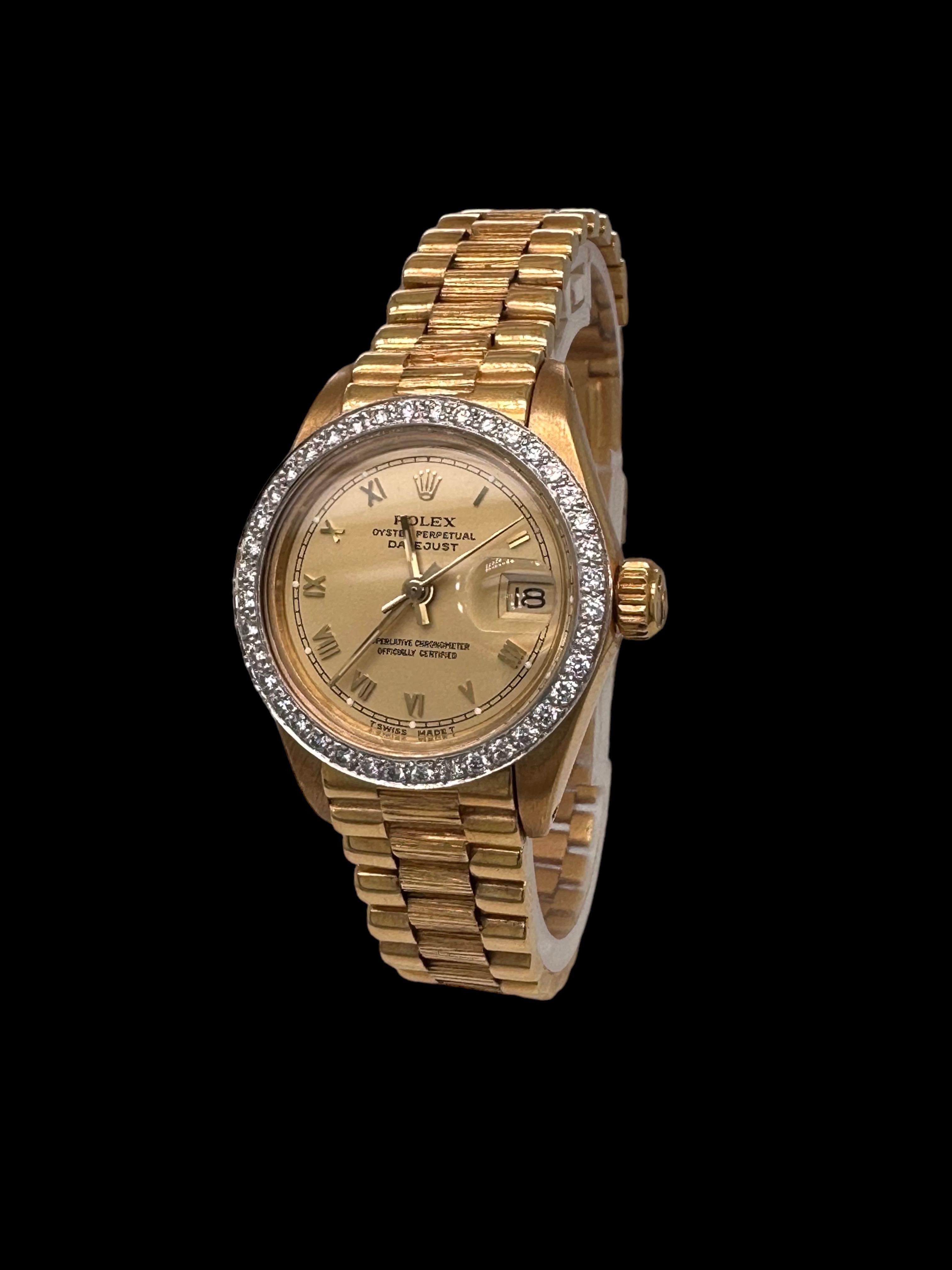 18kt Yellow Gold Rolex President Lady Oyster Datejust, Set with Diamonds 

Movement: Automatic

Functions: Hours, minutes, sweep seconds, date

Case: 18 kt. yellow gold, diameter 26 mm, height 10.80 mm, sapphire glass with magnifying lens over date