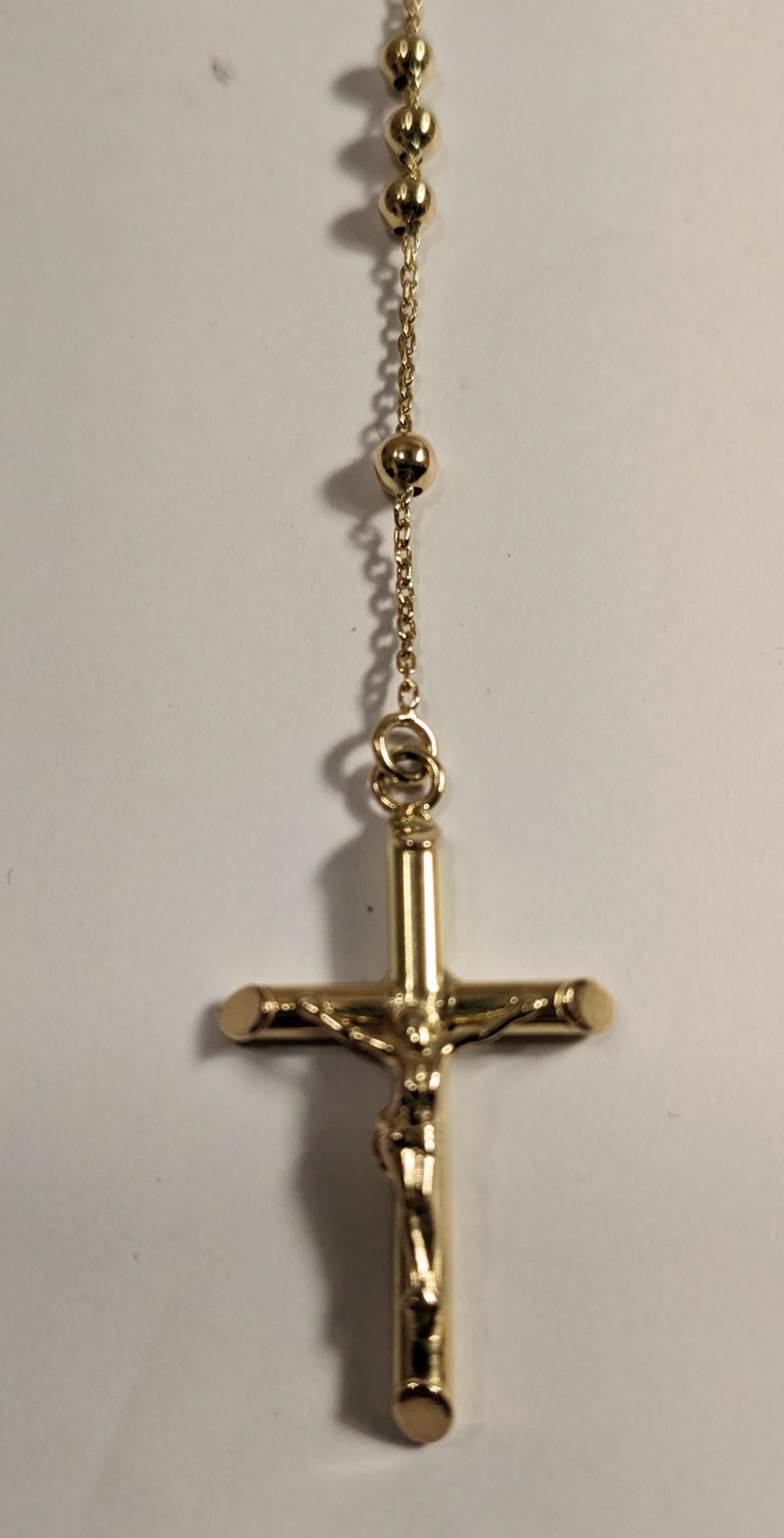 18k Gold Rosenkranz mit  Jungfrau und Kreuz mit Christus.
4mm-Kugeln. Länge bis zur Medaille: 40 cm. Von der Medaille zum Kreuz: 9 cm.
Das Gewicht beträgt 7,8 Gramm.

 Alle Juwelen von Pradera sind garantiert und stammen aus nachhaltigen und