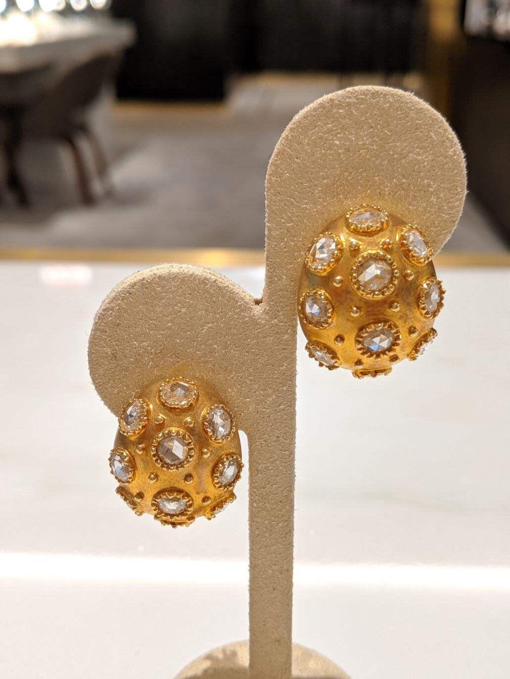 Chic and classic, these oval shaped bombay earrings have each been set with ten round rose cut diamonds. The yellow gold matte finish is a beautiful back round for the  bezel set diamonds.The earrings measure approximately 1