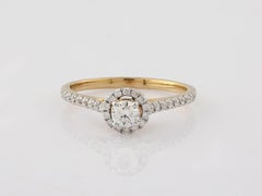 Anello solitario aureolato con diamante tondo e brillante in oro giallo 18KT