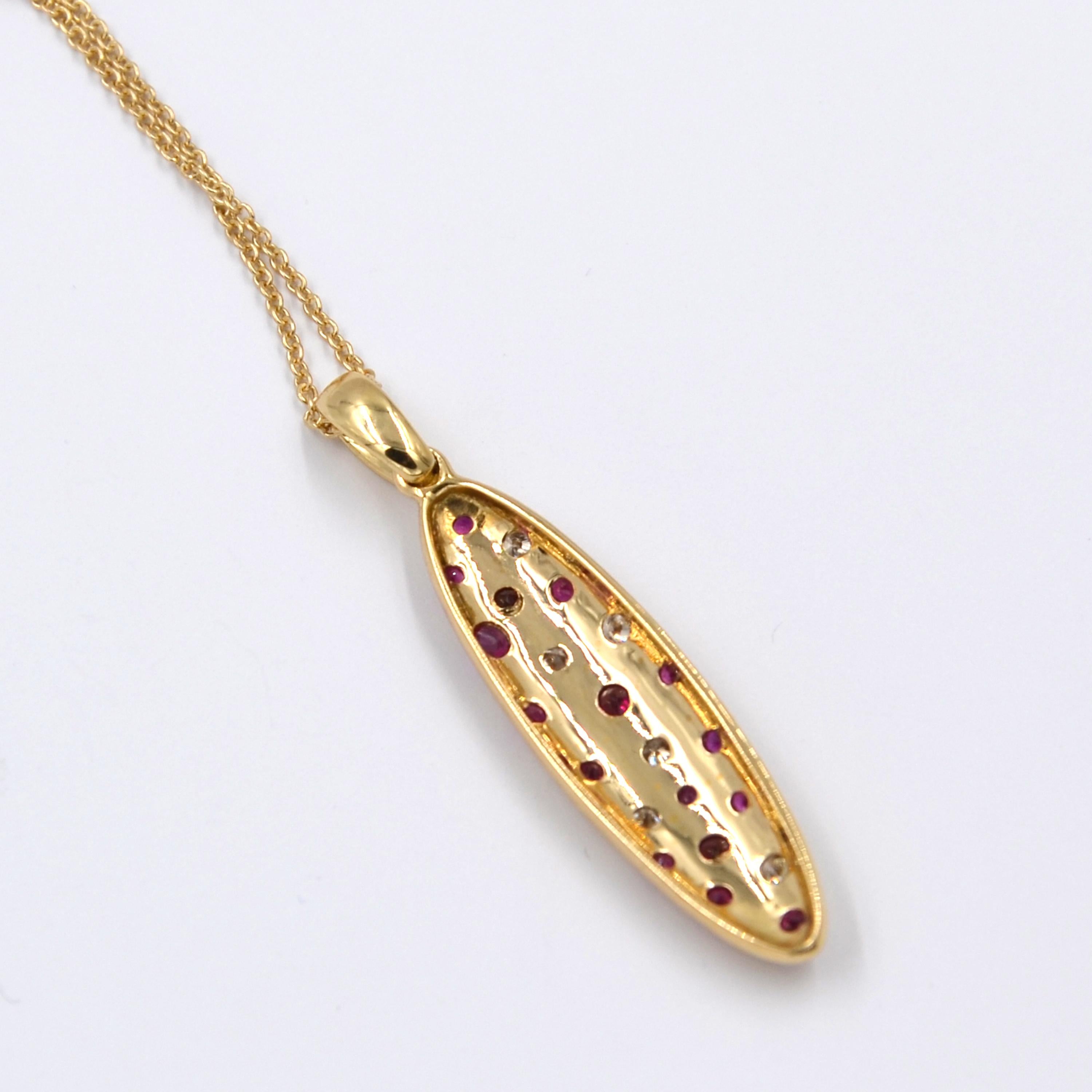 18kt Yellow Gold Rubies and Brown Diamonds Garavelli Matte Pendant with chain. The chain is in 18kt yellow gold. The chain lenght is cm 48 with a loop at 38   The pendant lenght is mm 40 
The front gold surface is hand hammered to create a matte