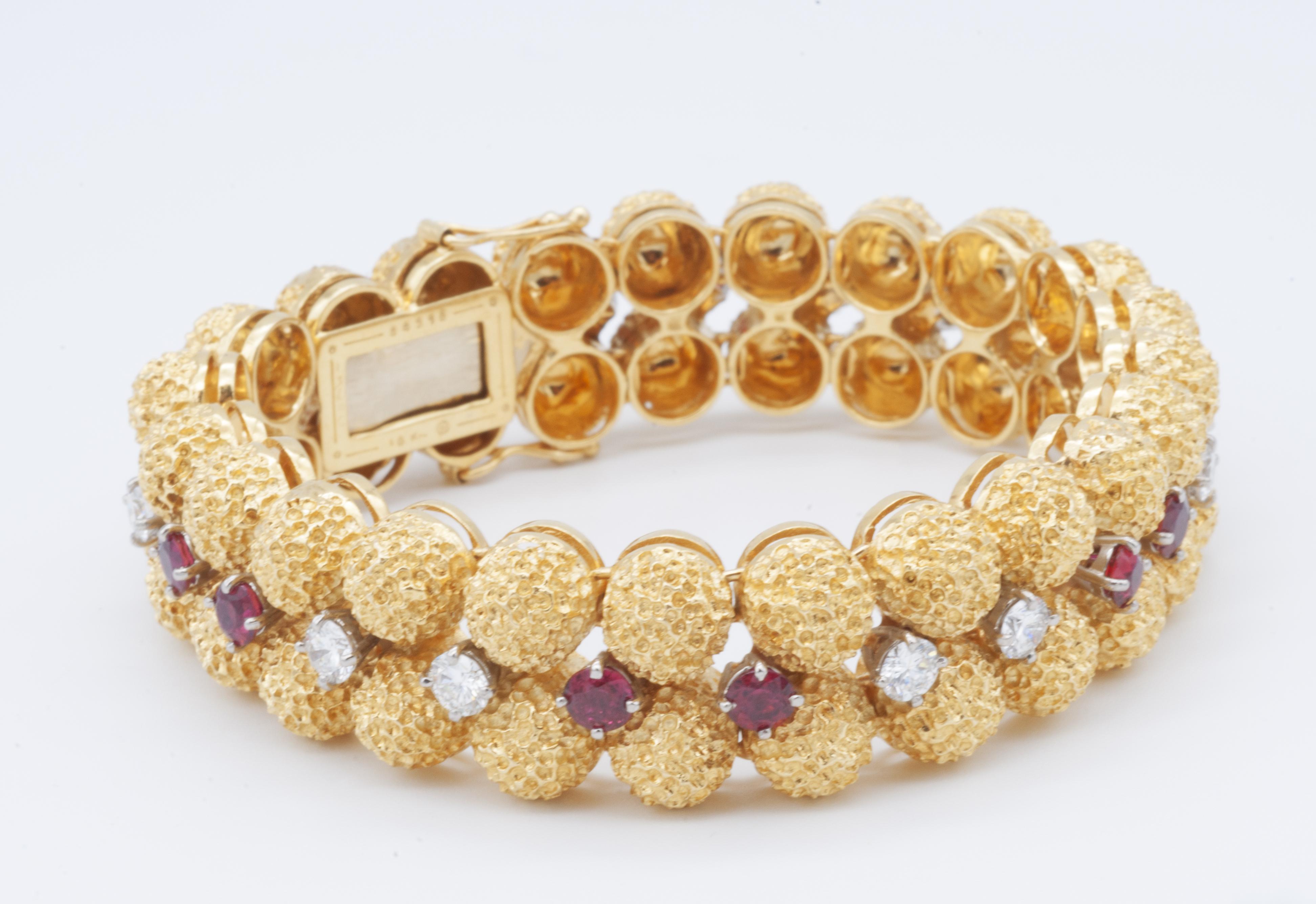 One lady's stamped 18kt Yellow Gold, Ruby and Diamond Bracelet designed by Oscar Heyman. Numbered 84273. The bracelet contains 11 round brilliant full cut diamonds with a total weight of 2.75ct. They are F color, VS1 in clarity. The bracelet also