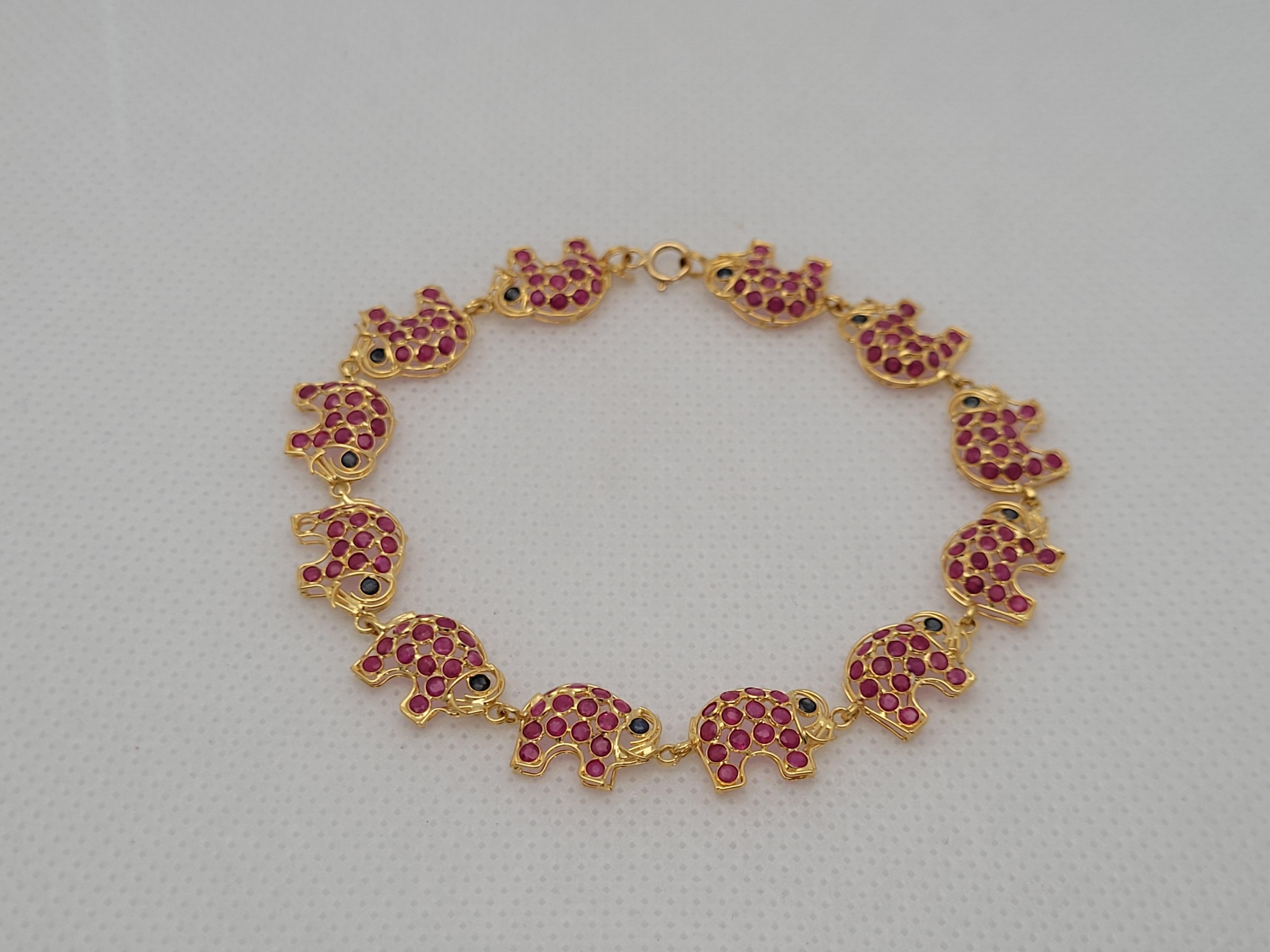 The 18kt Yellow Gold Ruby Sapphire Elephant Link Bracelet is a stunning piece of jewelry that combines elegance and charm. Crafted in high-quality yellow gold, this bracelet features a unique design of elephant links adorned with vibrant rubies and