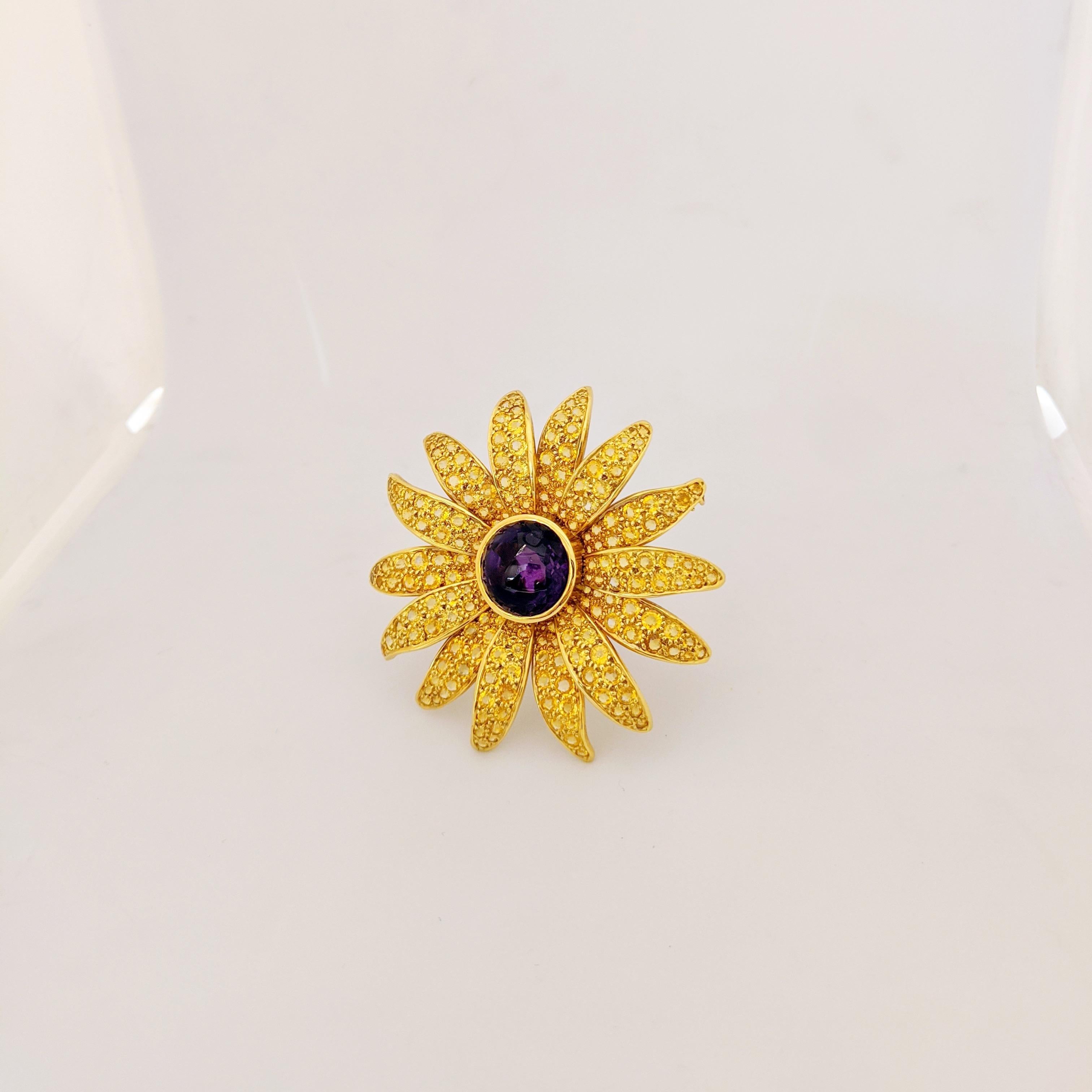 Hello Sunshine!!
18 karat yellow gold Sunflower brooch . Each of the 14 petals have been meticulously set with round brilliant cut Yellow Sapphires. The center of the flower is set with a cabachon Amethyst in a bezel setting. The brooch measures