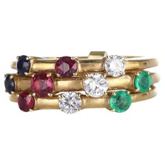 Anillo triple de oro amarillo de 18 quilates con diamantes, rubíes, zafiros y esmeraldas