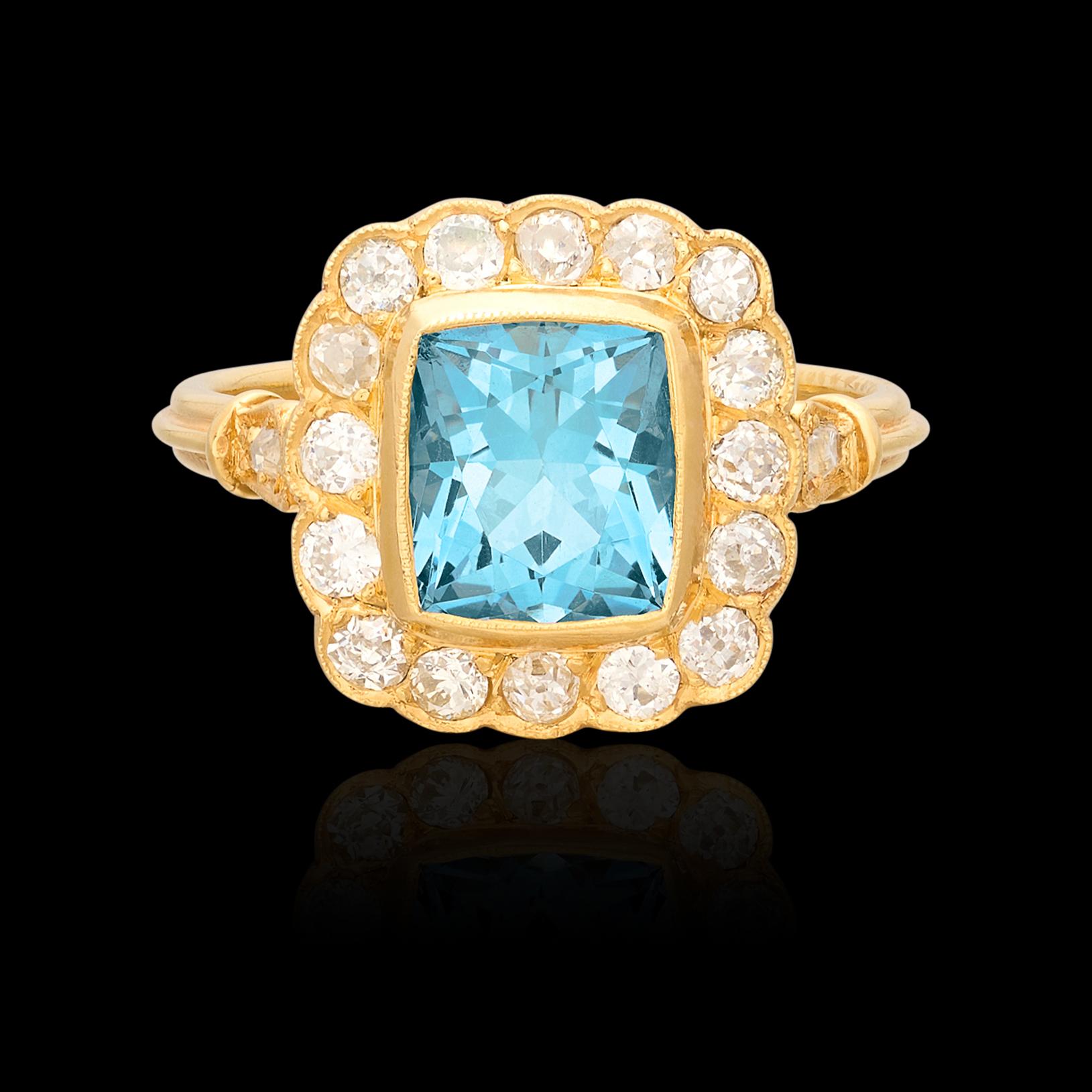 The perfect pop of color to spice up any hand! This 18 karat yellow gold stunning ring features at its center a vibrant rectangular cut aquamarine weighing 1.80 carats surrounded by a halo of antique old cut natural diamonds along with two accent