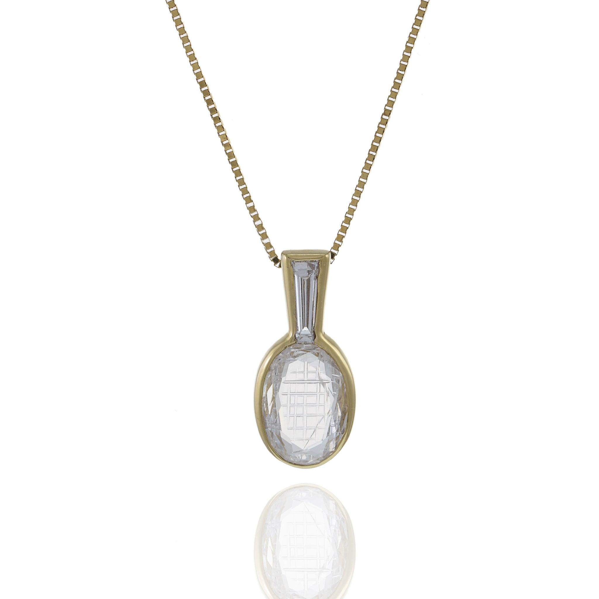 This unique vintage pendant features a tennis racket design, crafted in 18KT yellow gold. The pendant showcases a stunning combination of diamonds, including a hand-carved oval rose cut diamond and tapered baguette diamonds, totaling 1.00 carat. The