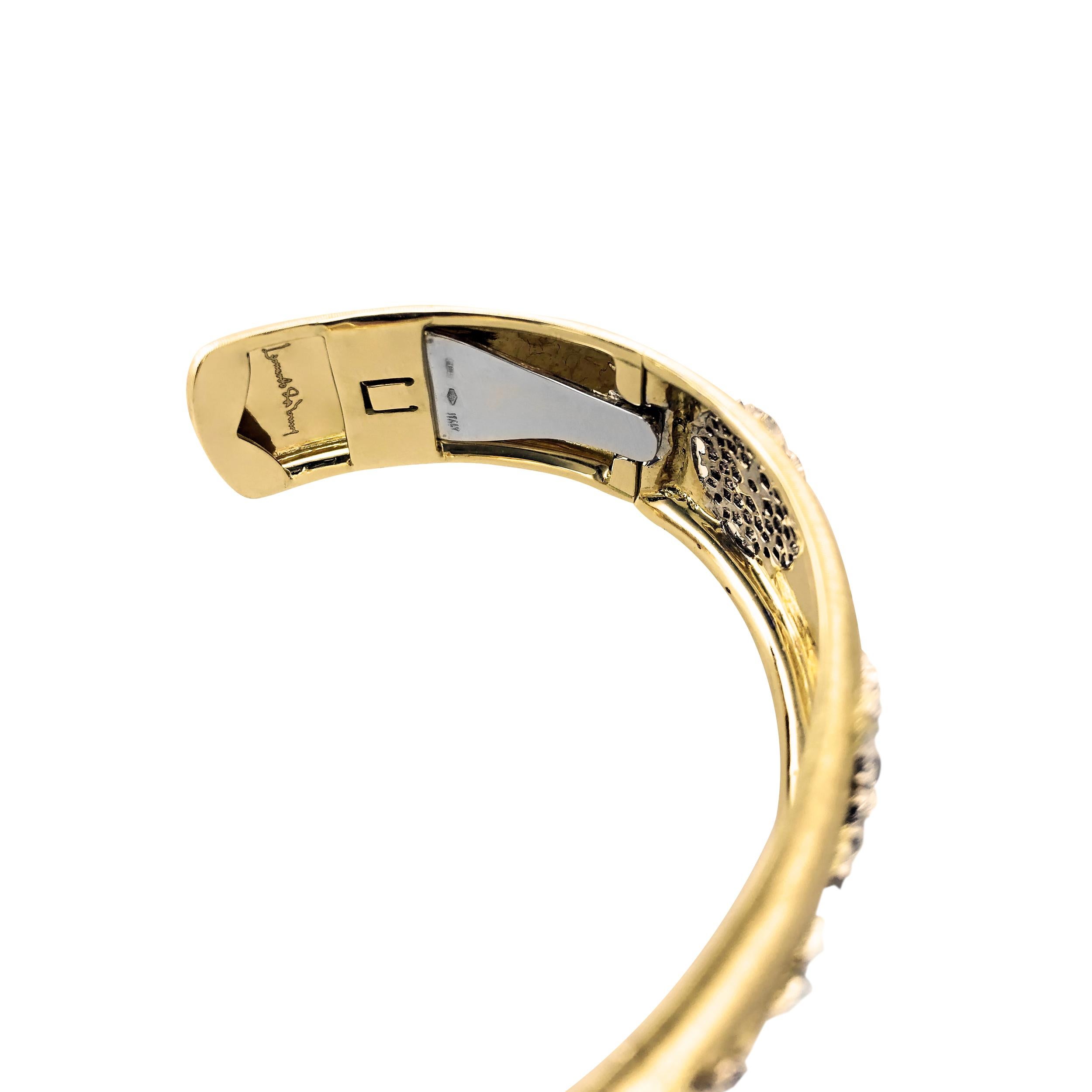 This 18Kt yellow Gold Ginevra cuff bangle is sprinkled with 0.47 Carats of Leonardo da Vinci Cut diamonds.

The matted Yellow Gold cuff bangle is uniquely designed with 5 large pentagons of white gold. Each pentagon is delicately crafted with mini