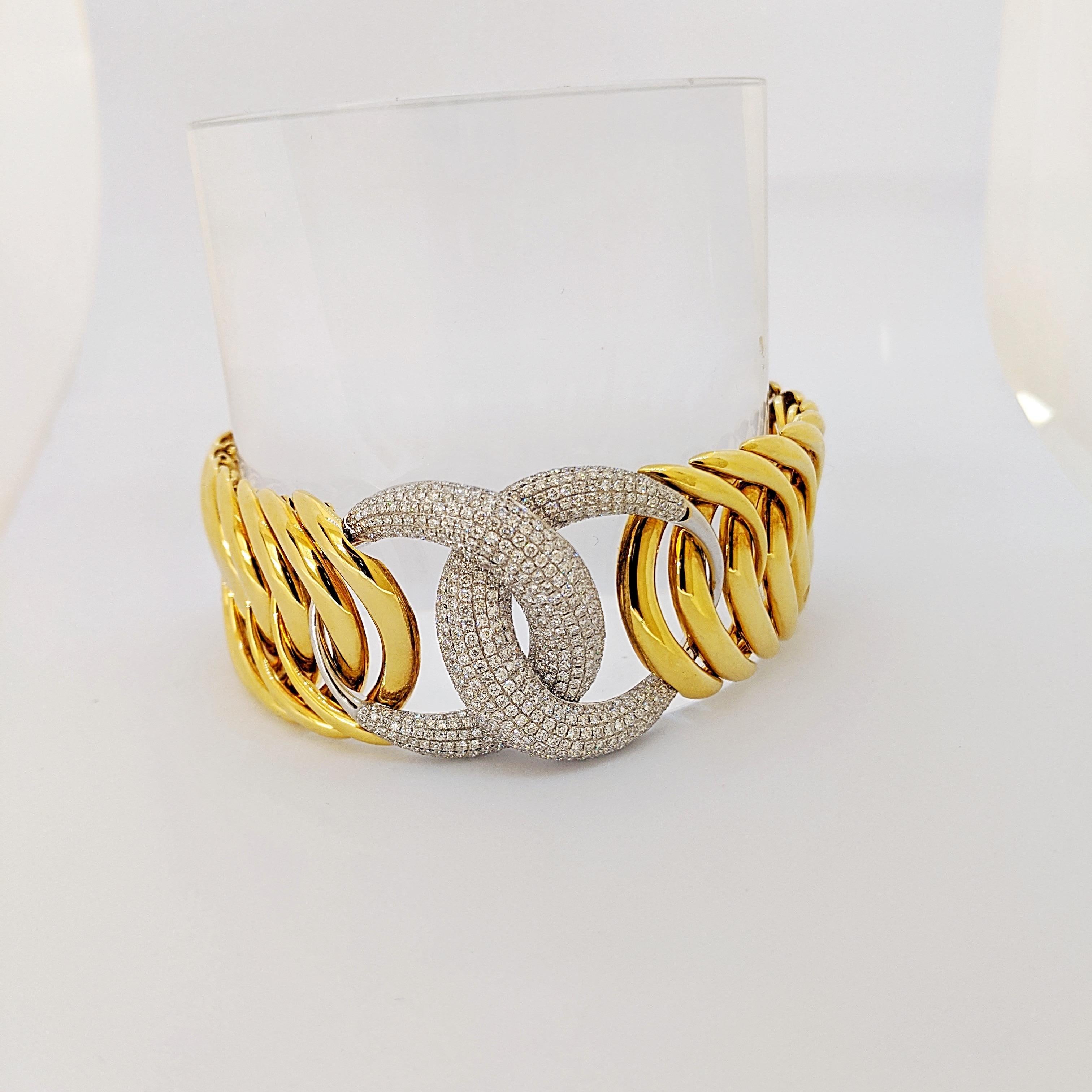 Designed for Cellini. The centerpiece of this lovely bracelet is the two interlocking pave diamond set crescent moons .The pattern continues with the hi polished yellow gold interlocking links. When closed the bracelet is seamless. The bracelet