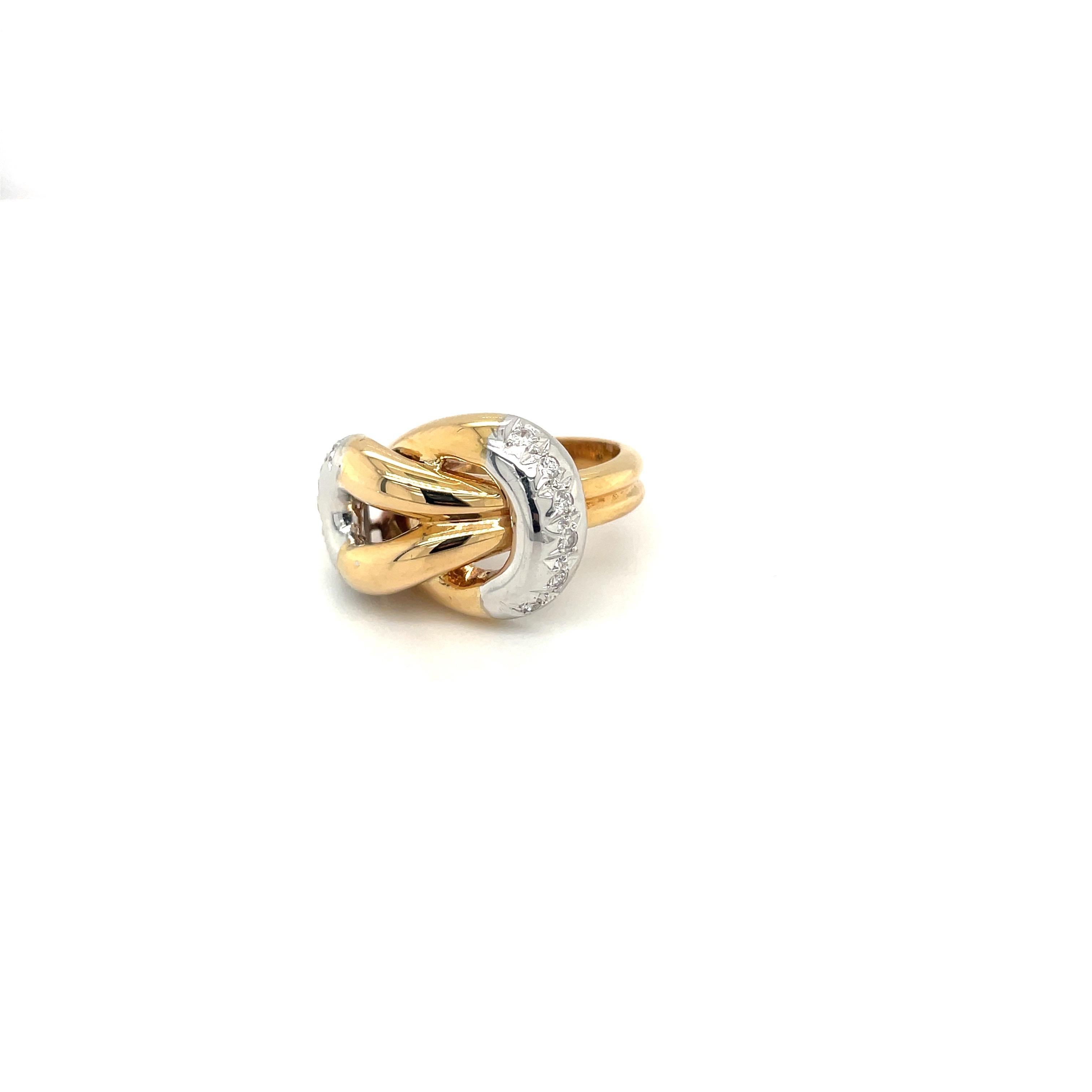 Classic 18 karat yellow and white gold knot ring. Round brilliant diamonds 0.23 carats are set in the white gold ends of the ring.
Ring size 5.5