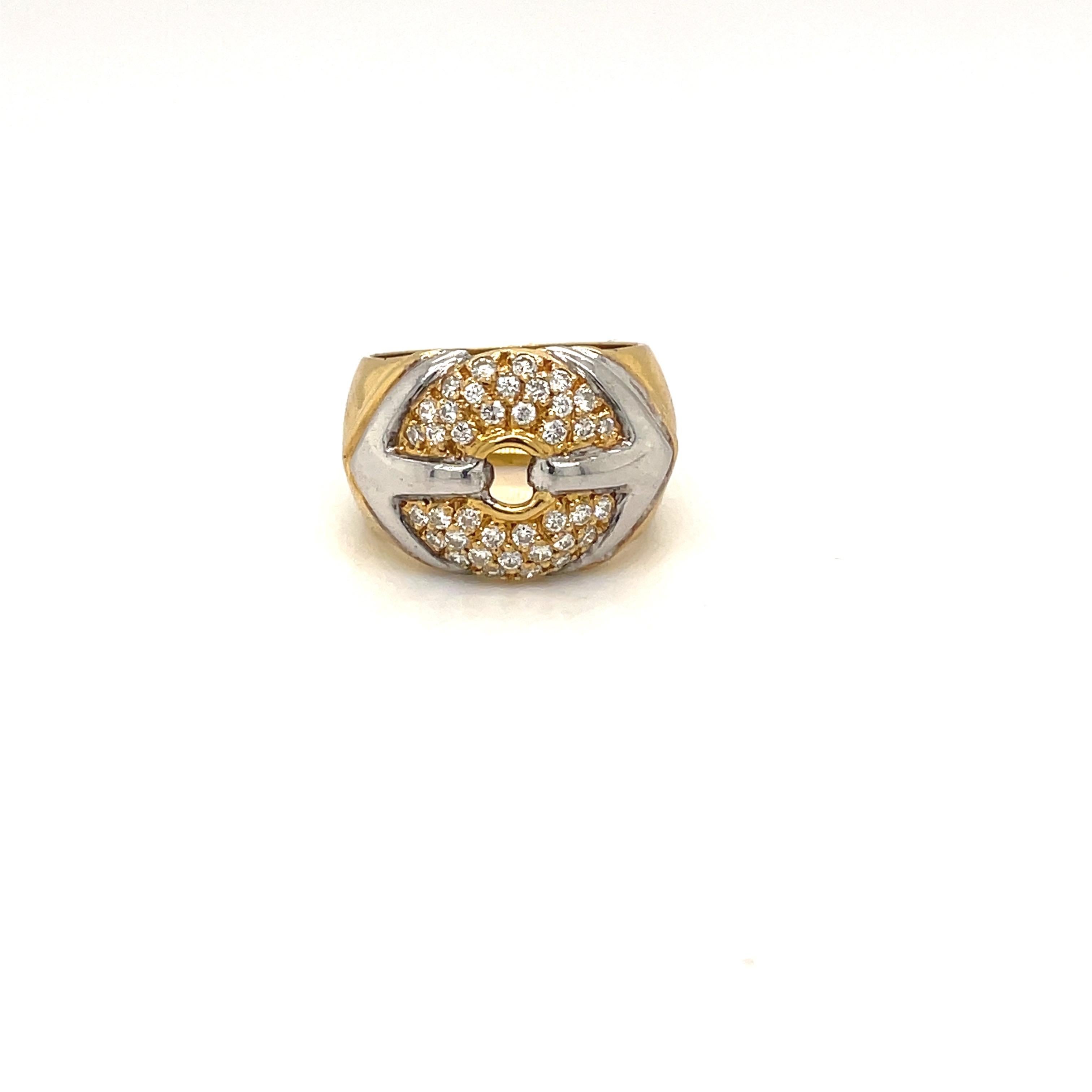 18 karat yellow gold band style ring. The center of the ring is set with round brilliant diamonds in a circular motif. The center motif is accented with white gold.
Total diamond weight 0.63 carat
Stamped 750 LEB
Ring size 6
