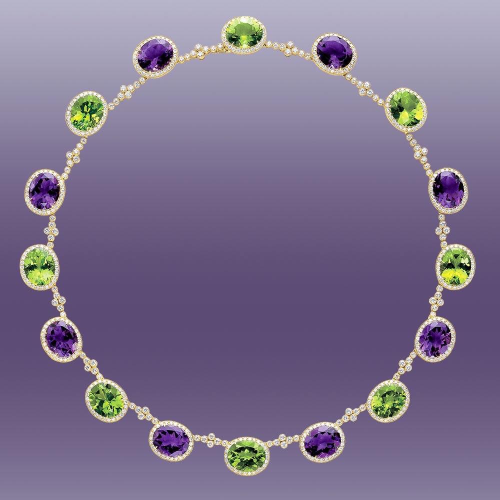 An important necklace beautifully designed with alternating oval Amethyst and Peridot stones . Each oval stone is set in a yellow gold and Diamond bezel setting.  Connecting the stones together are 8 smaller bezel set Diamonds. This allows for added
