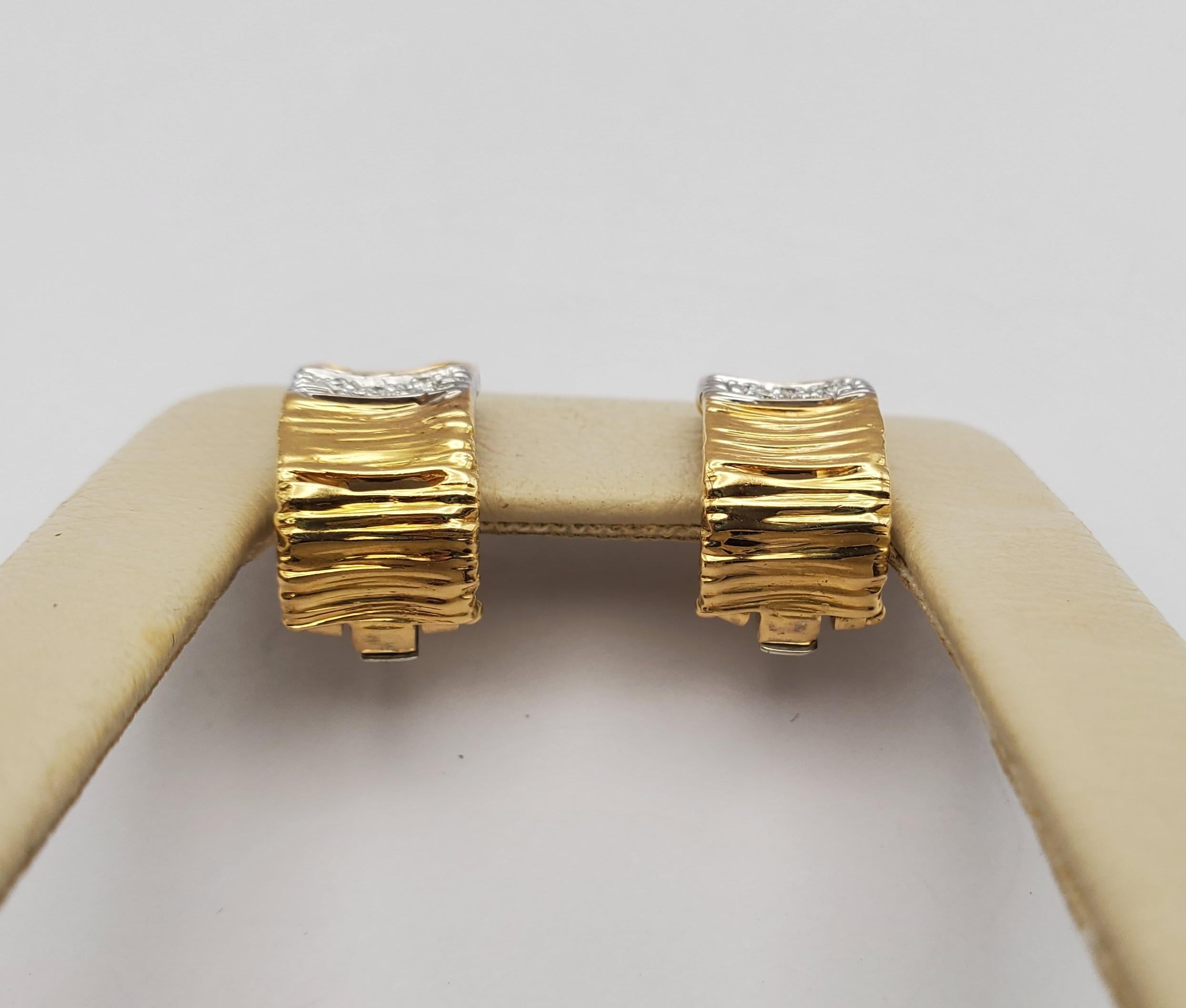 18k Roberto Coin Diamond J-Hoop omega back earrings from the Elephant (Elefantino) Collection. These elegant Roberto Coin earrings are crafted of 18k yellow and white gold and set with round brilliant cut diamonds. The diamonds have a combined