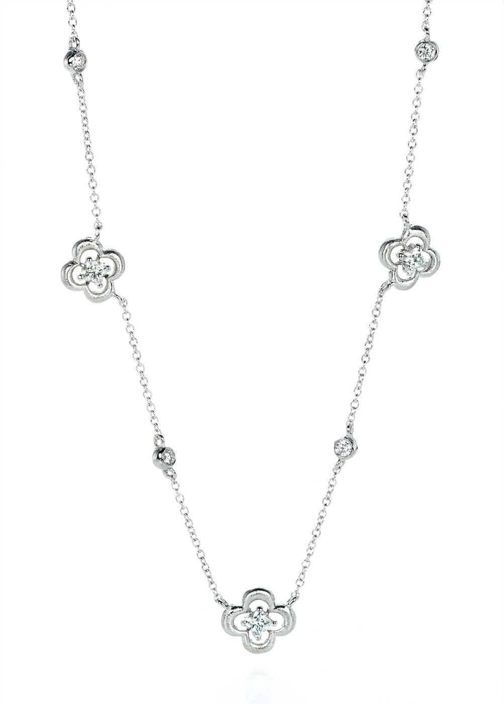 18KT white gold station diamond flower necklace. 3 LILY CUT ® flower shape diamond H color VS SI clarity  0.53 cts . additional 0.22 ct round diamond accent .   17 inch with a link to shorten to 16 inch . 