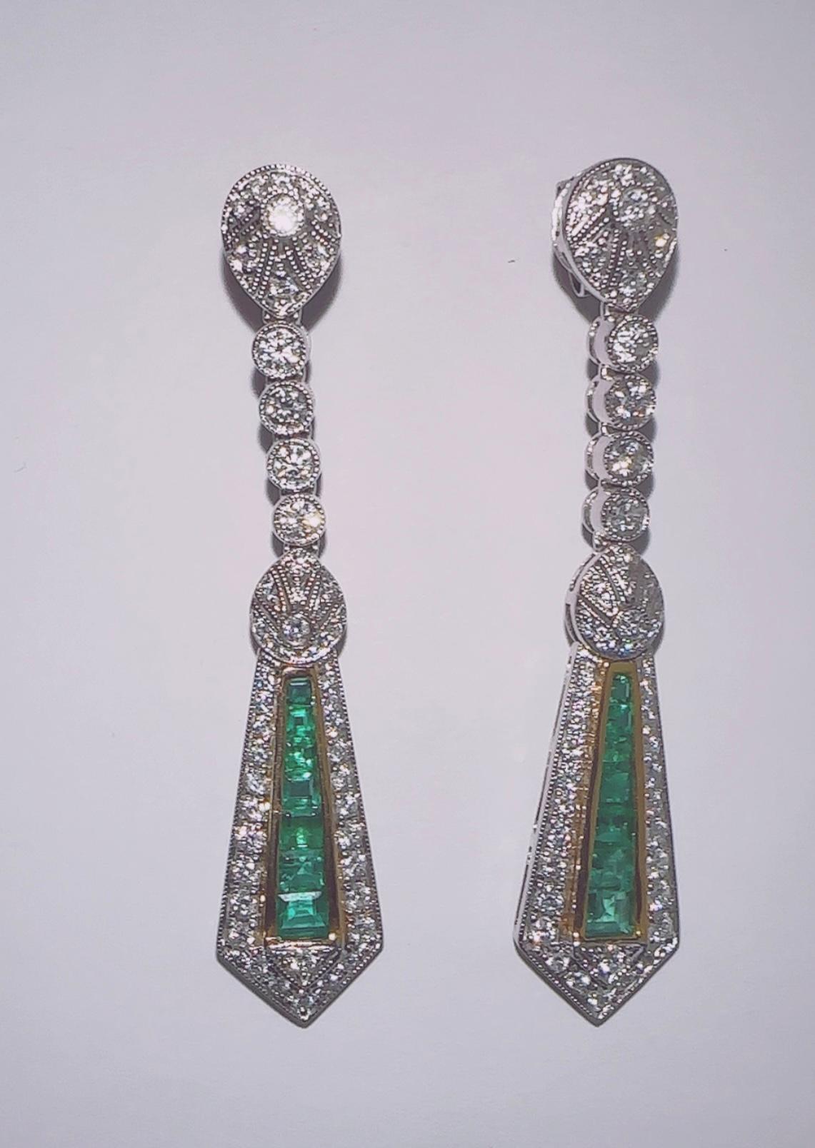 18K White Gold Diamond and Emerald long unique earrings, Special cut perfectly matched emeralds pairs with an antique diamond look. 